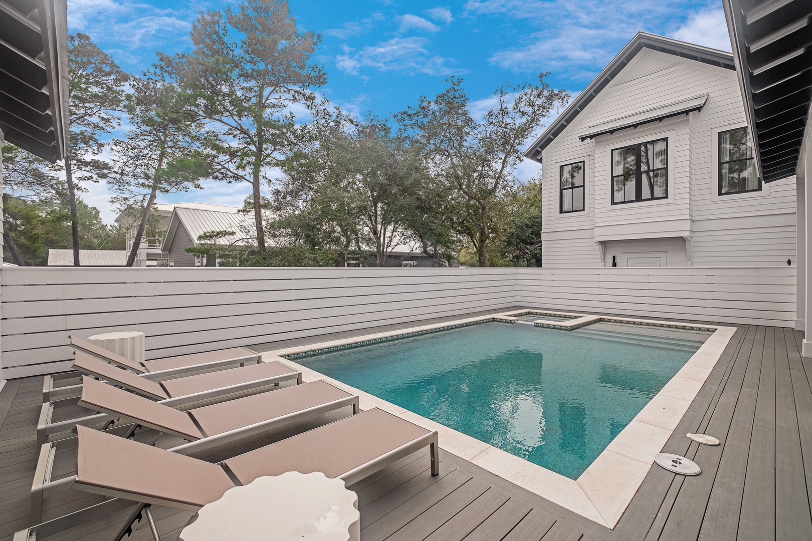 Your private pool oasis awaits, complete with lounge chairs and a secluded deck for ultimate relaxation.