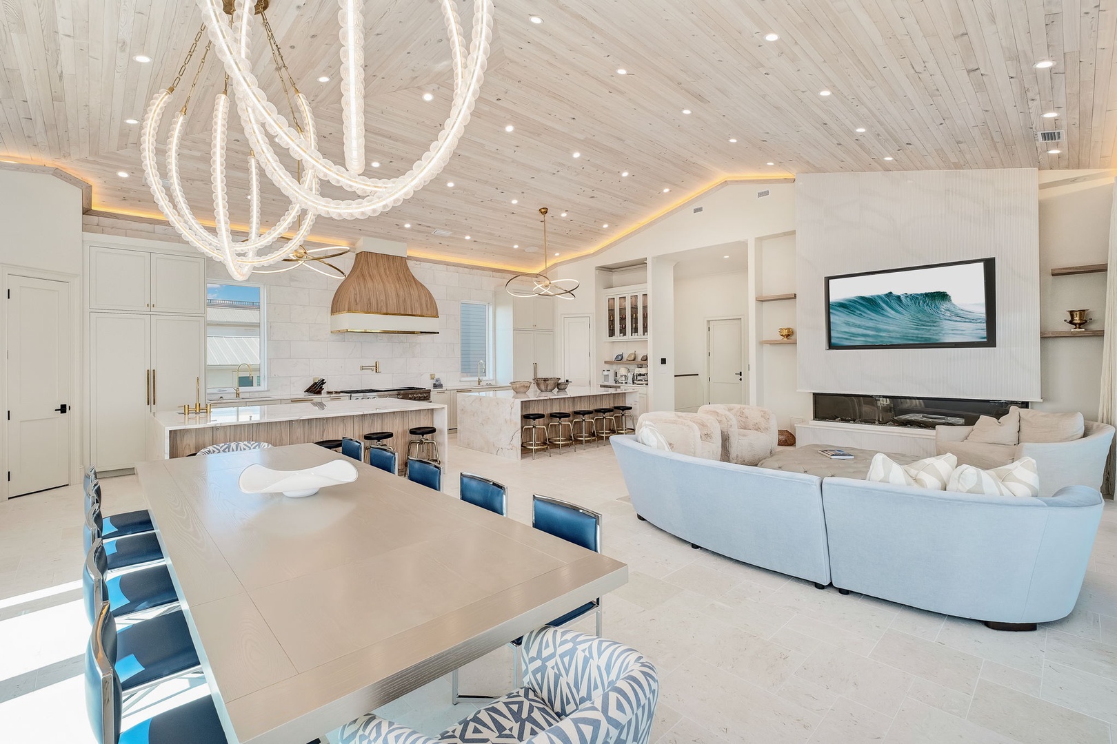 Picture yourself in this stunning open-concept retreat, where coastal elegance meets modern comfort. Relax on plush seating, gather around the spacious dining table, or whip up meals in your chef's kitchen—all under a show-stopping chandelier and whitewas