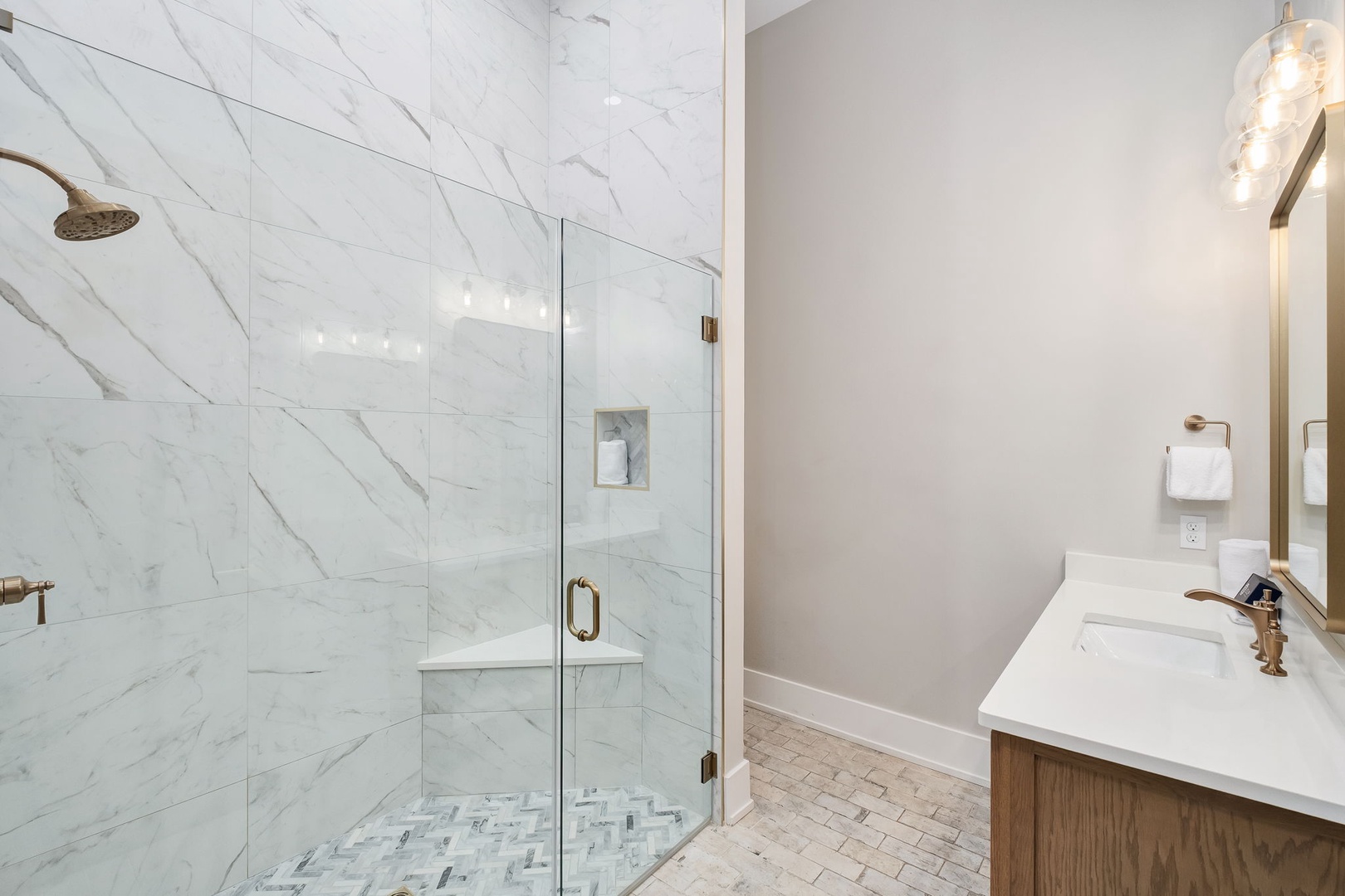 Unwind in your spa-like bathroom featuring elegant marble shower and modern fixtures for pure relaxation.