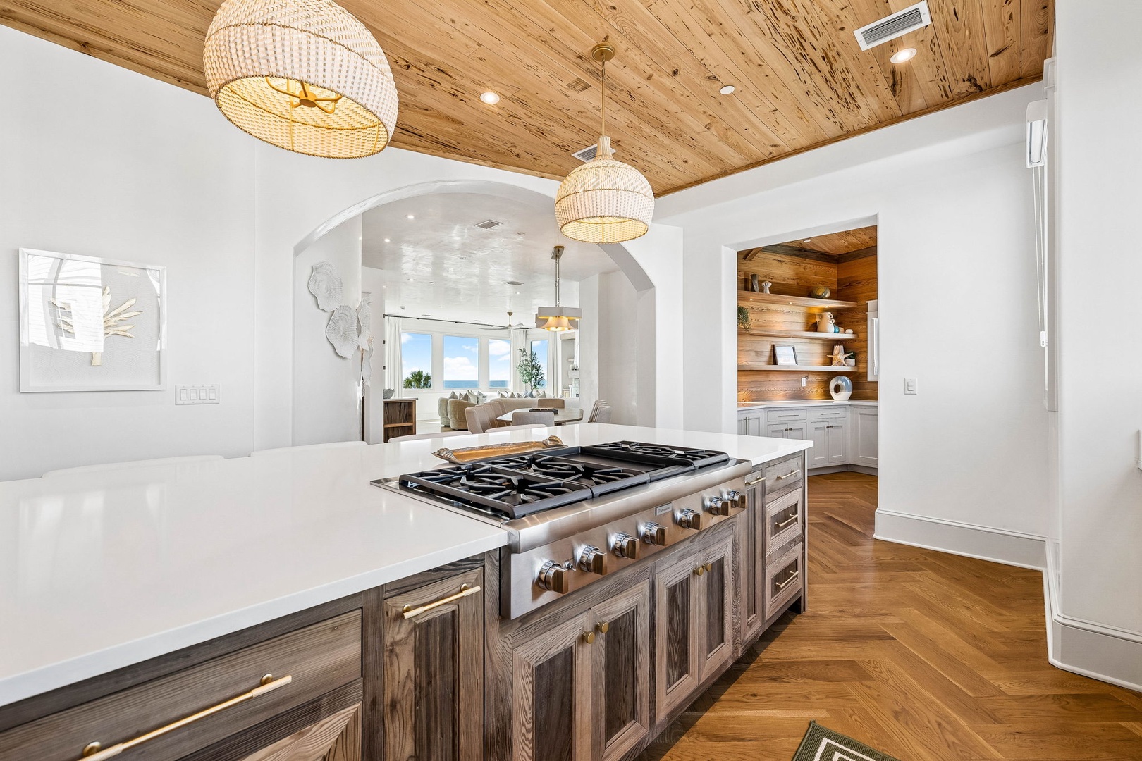 Step into a chef's dream kitchen where rustic warmth meets modern elegance. Cook gourmet meals on the professional-grade gas range while natural light flows through open archways, connecting you to inviting living spaces beyond.