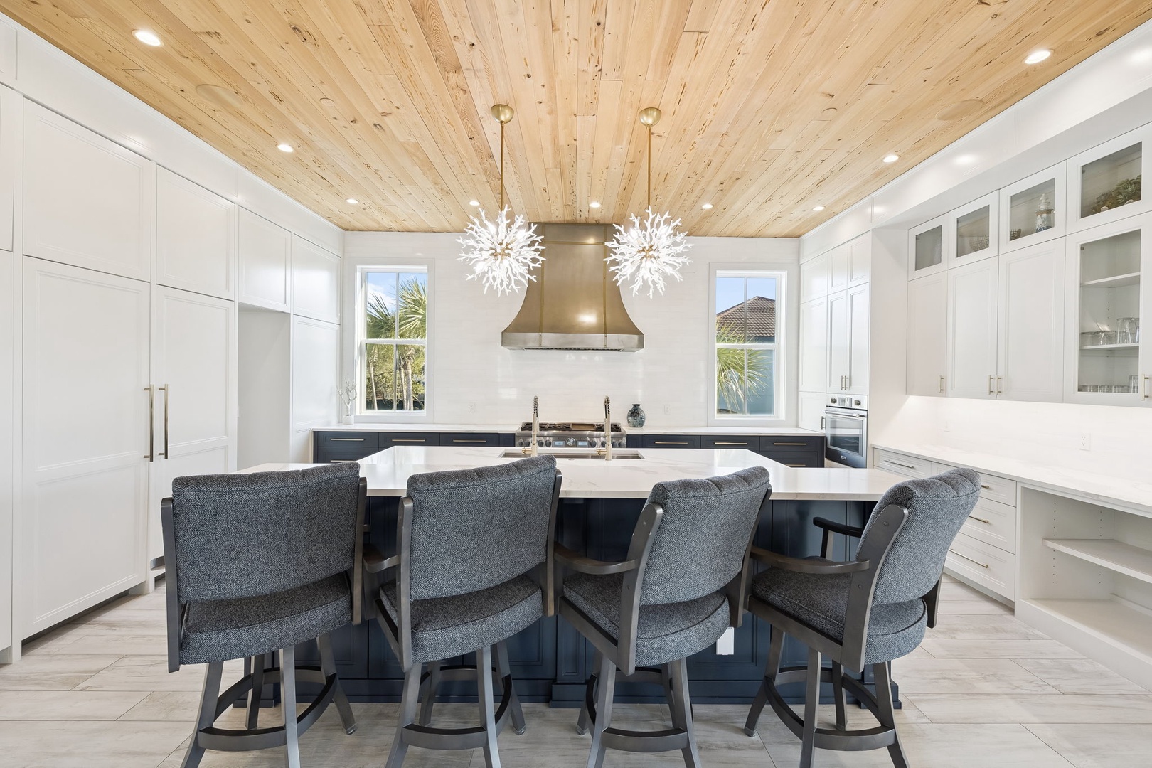 Your gourmet kitchen awaits with sparkling chandeliers, sleek countertops, and bar seating for memorable meal prep and conversations.