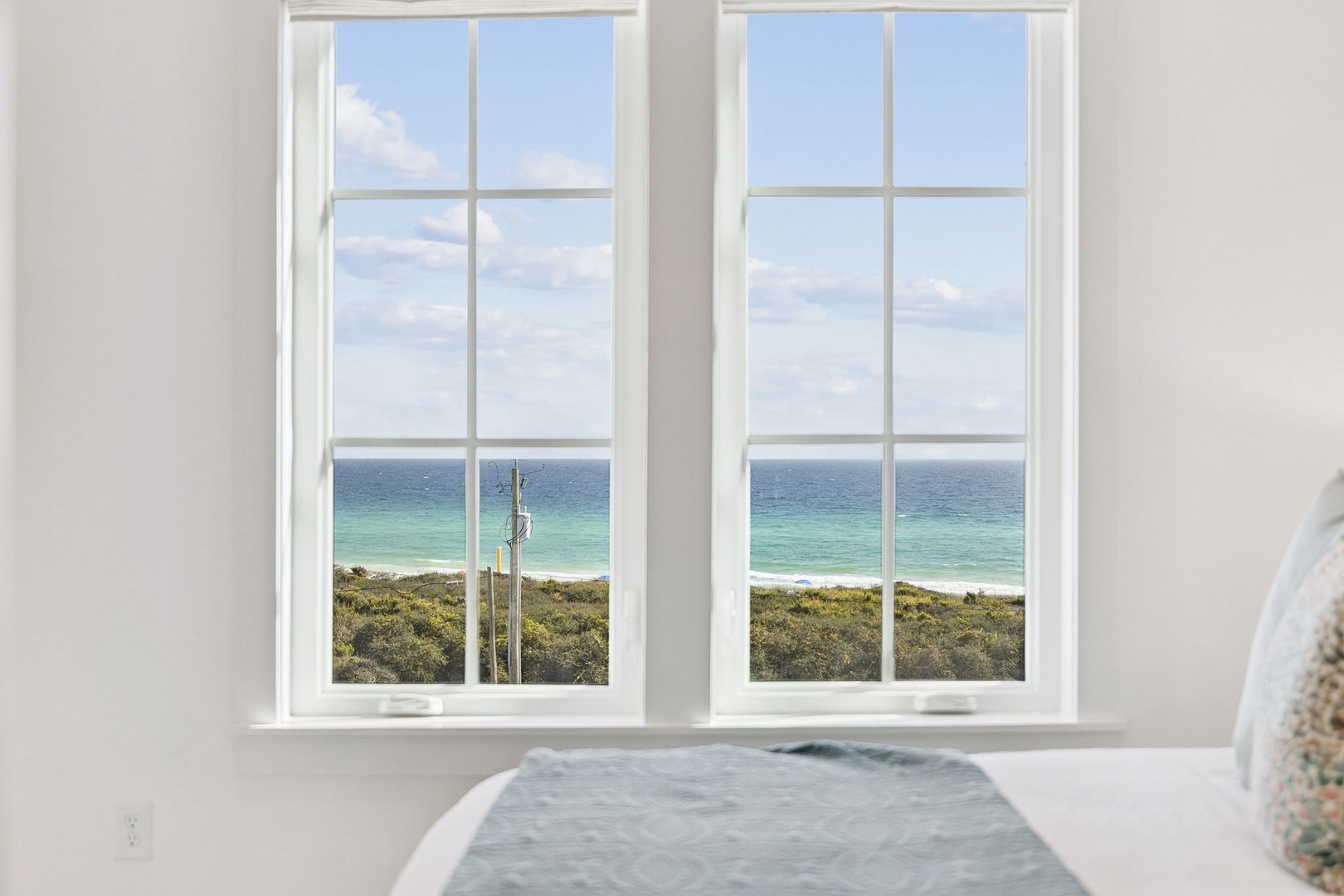 Soak in your private tub while gazing at stunning ocean views through bright windows—pure coastal luxury.