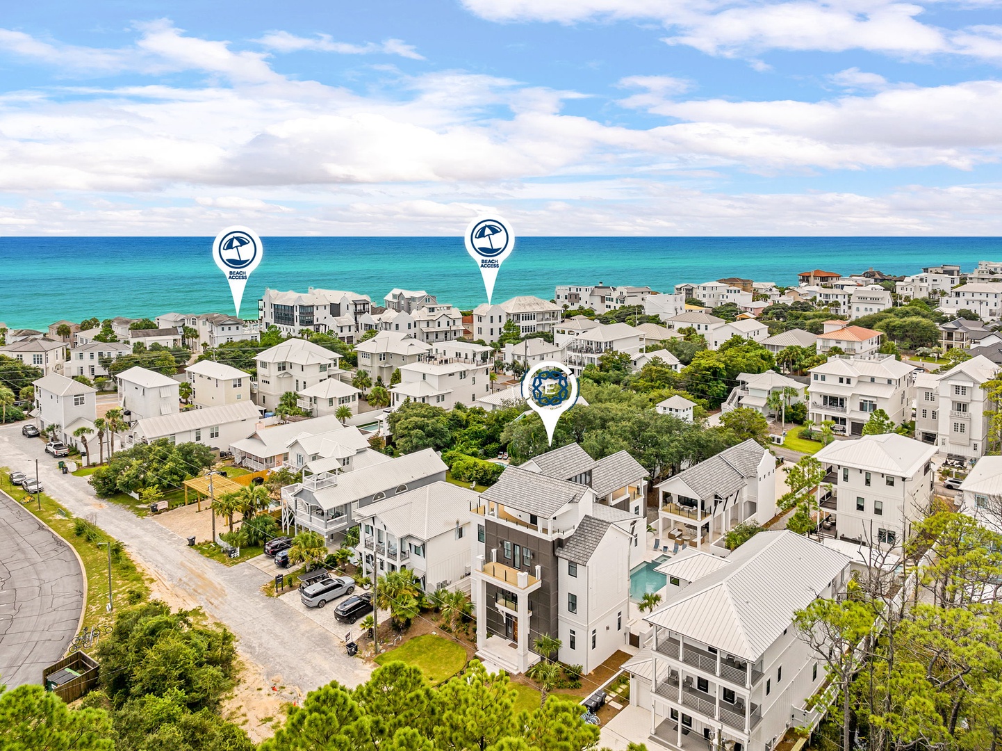 An aerial view reveals the property's prime coastal location, nestled within a serene neighborhood just moments from the beach, with the turquoise Gulf waters stretching endlessly beyond.