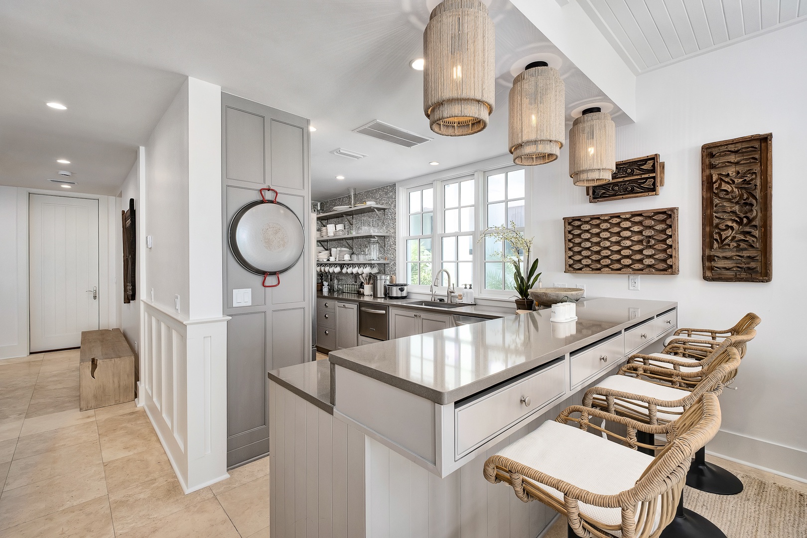 Your chef-inspired kitchen features sleek countertops, premium appliances, and stylish wicker seating perfect for morning coffee or evening conversations.