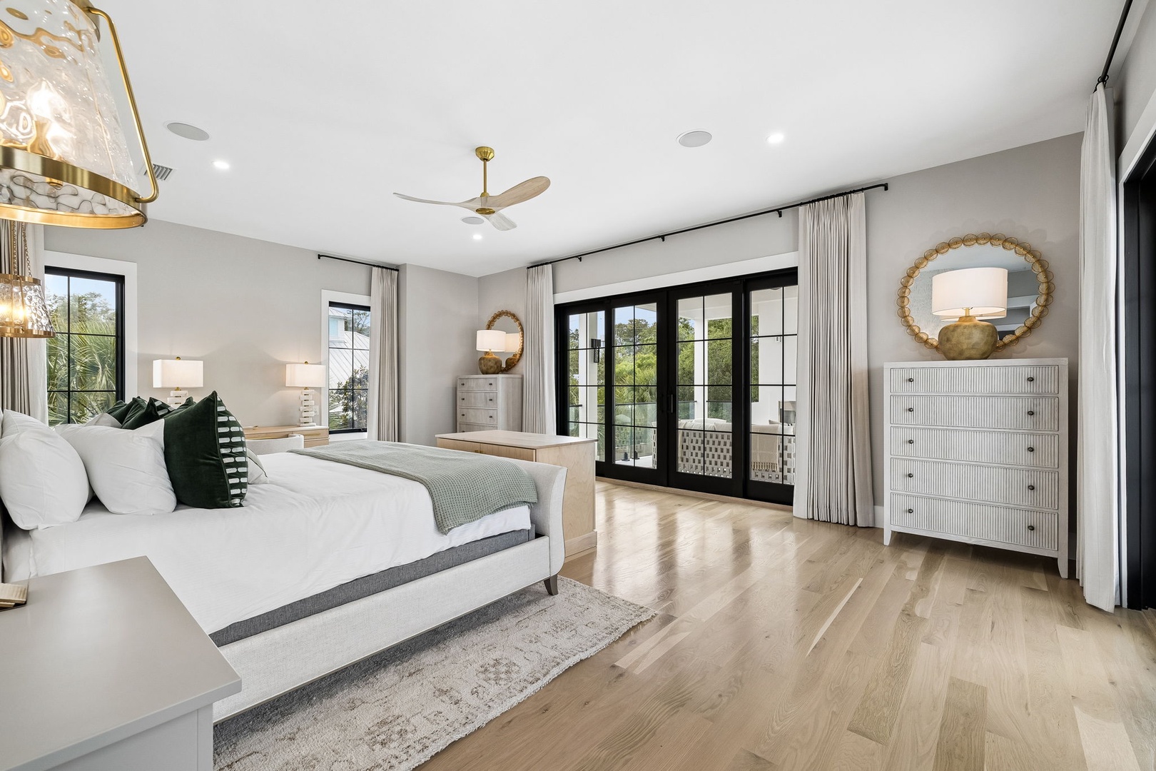 Sink into plush bedding and wake refreshed in your elegantly appointed bedroom, where natural light pours through French doors leading to your private balcony and breezes from the ceiling fan keep you comfortable.