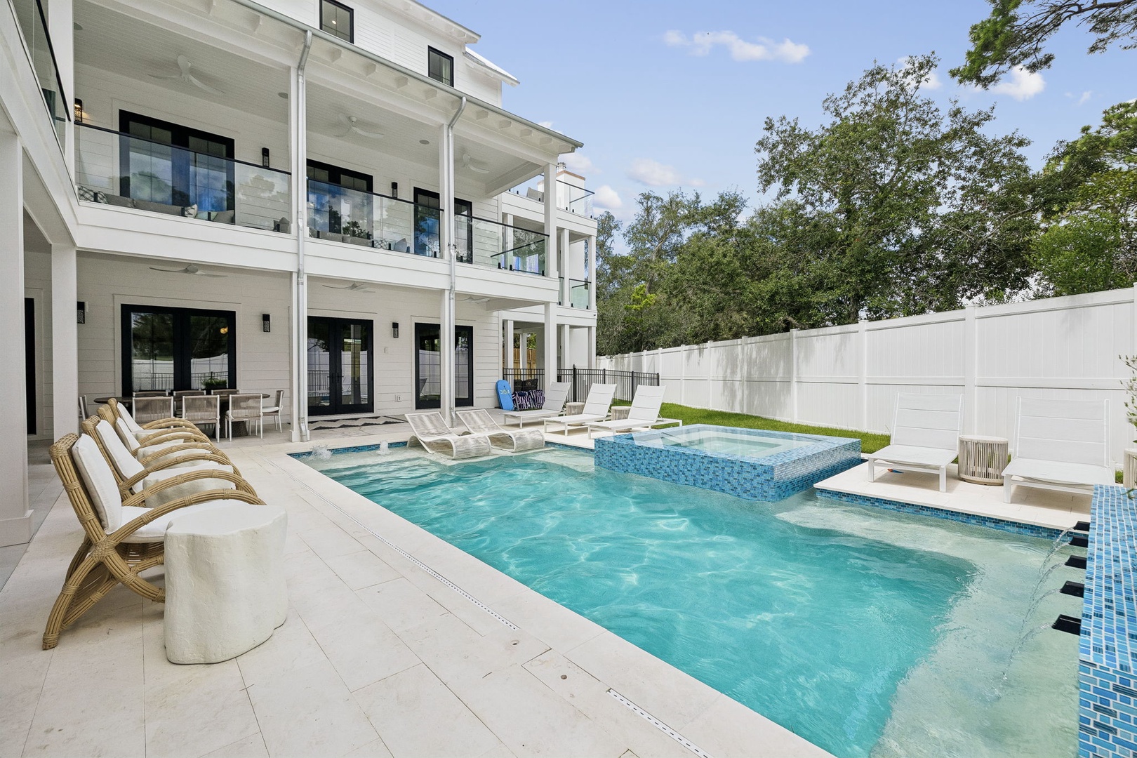 Inviting pool area with lounge chairs, spa, and shaded patio—your private retreat for sunny days and relaxing evenings under the trees.