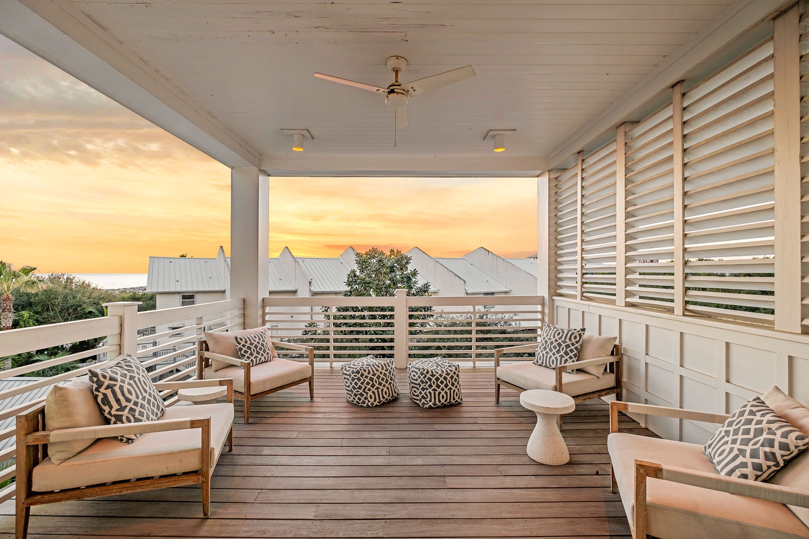 Unwind on your private covered terrace with plush seating as golden sunsets paint the sky beyond charming rooftops.