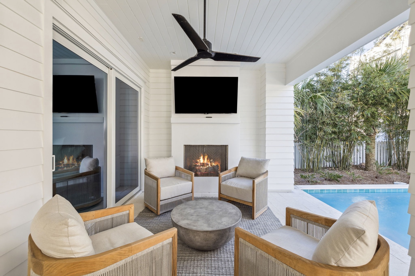 Unwind by your private poolside fireplace, where modern comfort meets tropical paradise in this elegant covered retreat.