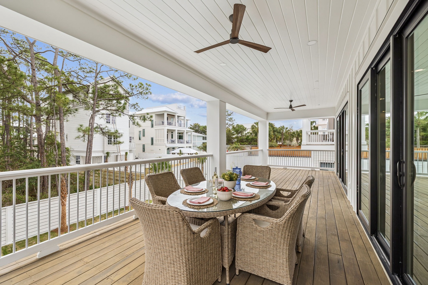 Enjoy alfresco dining on your covered deck with wicker seating for six and ceiling fans overhead.