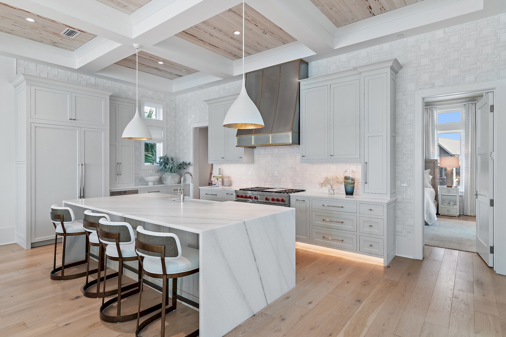 Step into your chef-worthy kitchen—marble island seating, pro-grade appliances, and warm wood tones invite you to gather, cook, and savor every moment here.