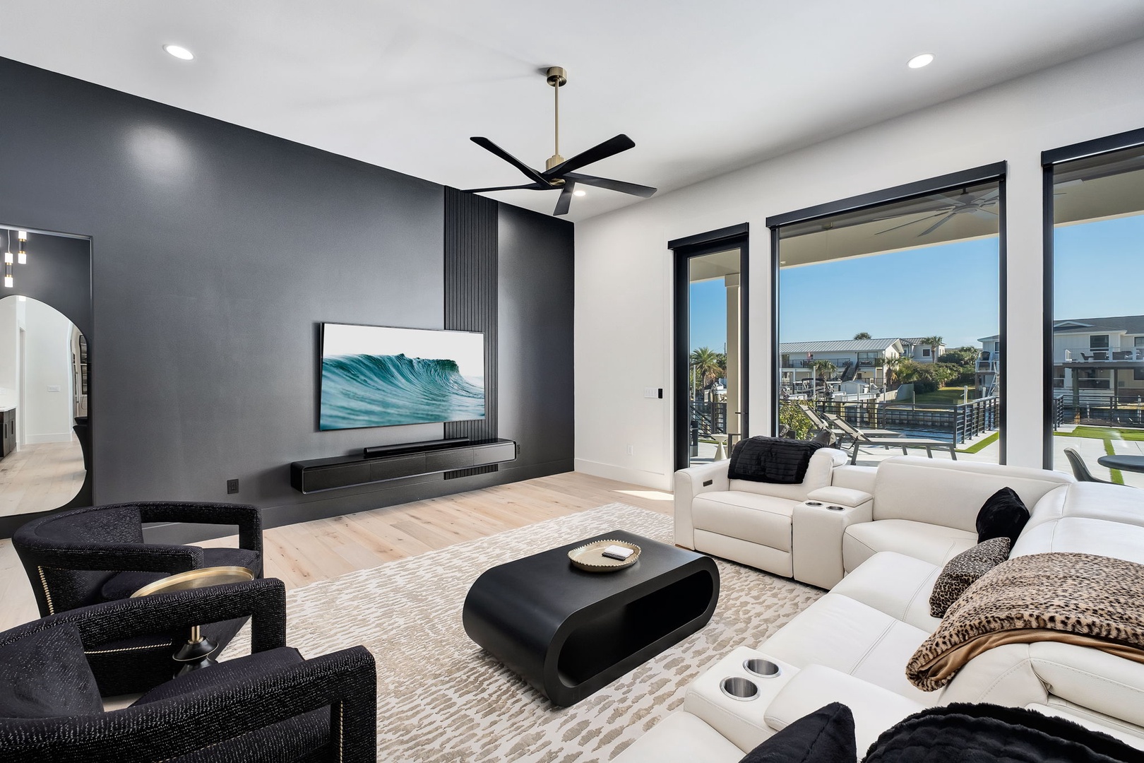 Sink into plush seating while ocean waves play on your wall-mounted TV. Floor-to-ceiling windows frame stunning views as you relax in modern luxury.