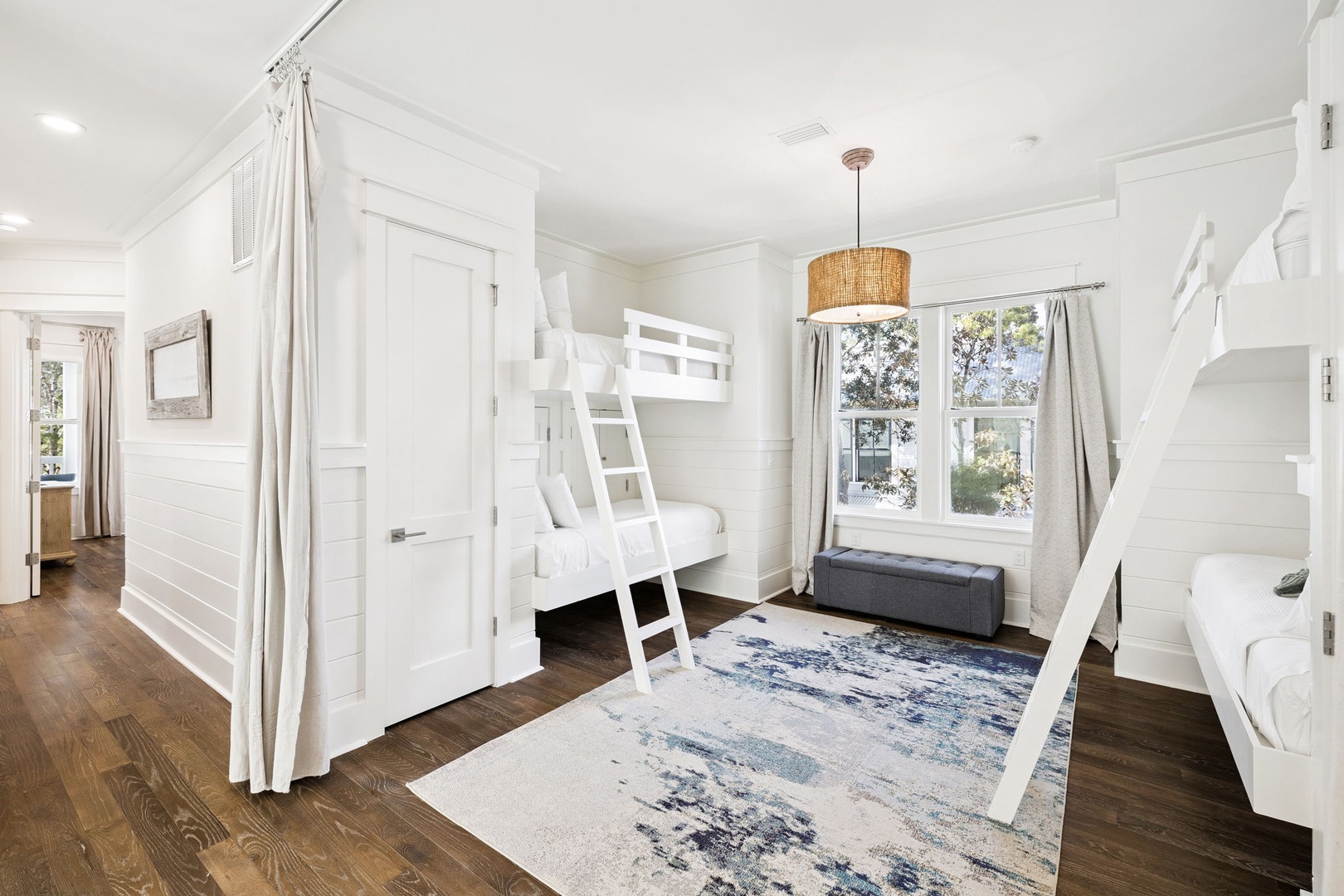 Your kids will love this bright bunk room with custom white beds and cozy reading nook by the window.