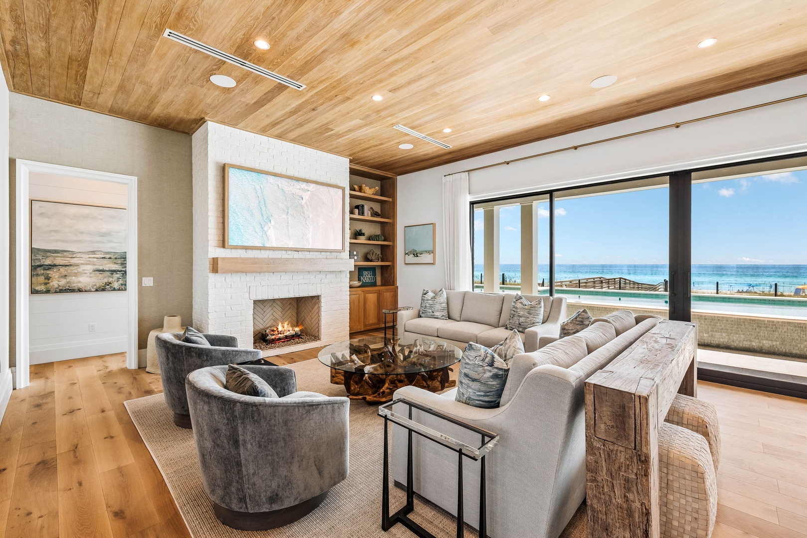Curl up by the fireplace or sink into plush seating with the ocean stretching endlessly beyond your windows—your perfect coastal retreat awaits.