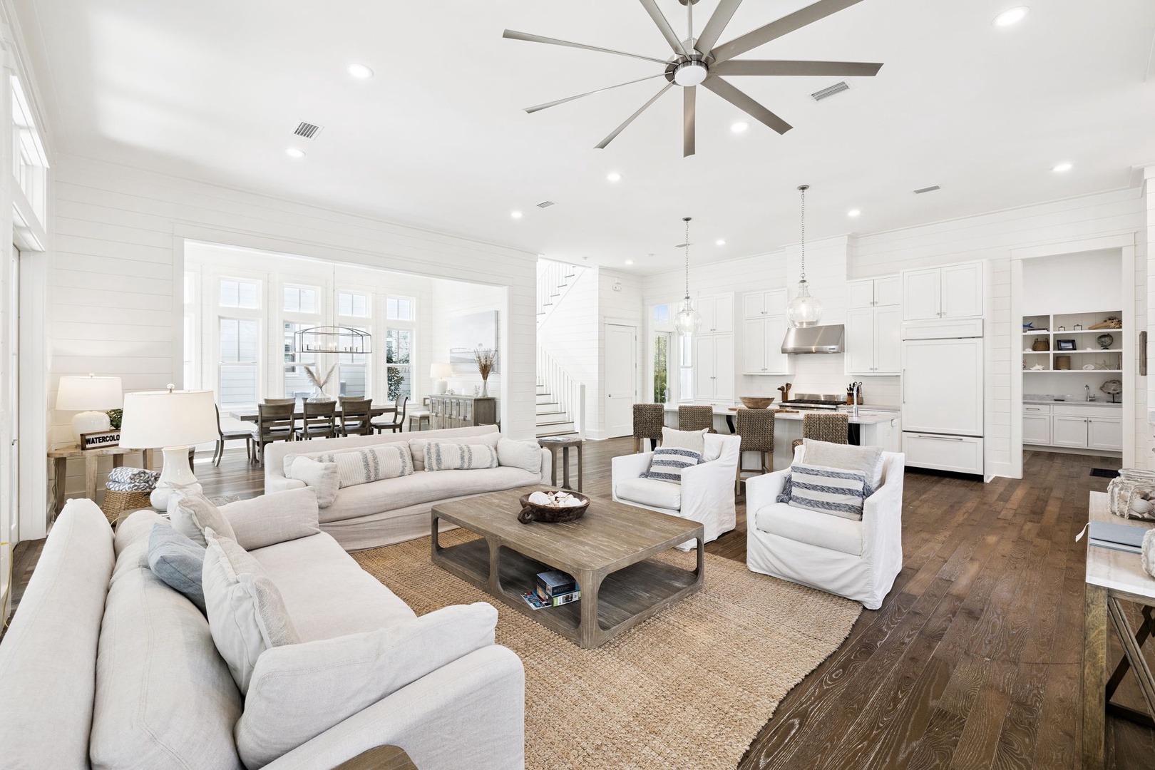 Sink into plush sofas in your bright, airy living space where coastal charm meets modern comfort—perfect for unwinding after beach days.