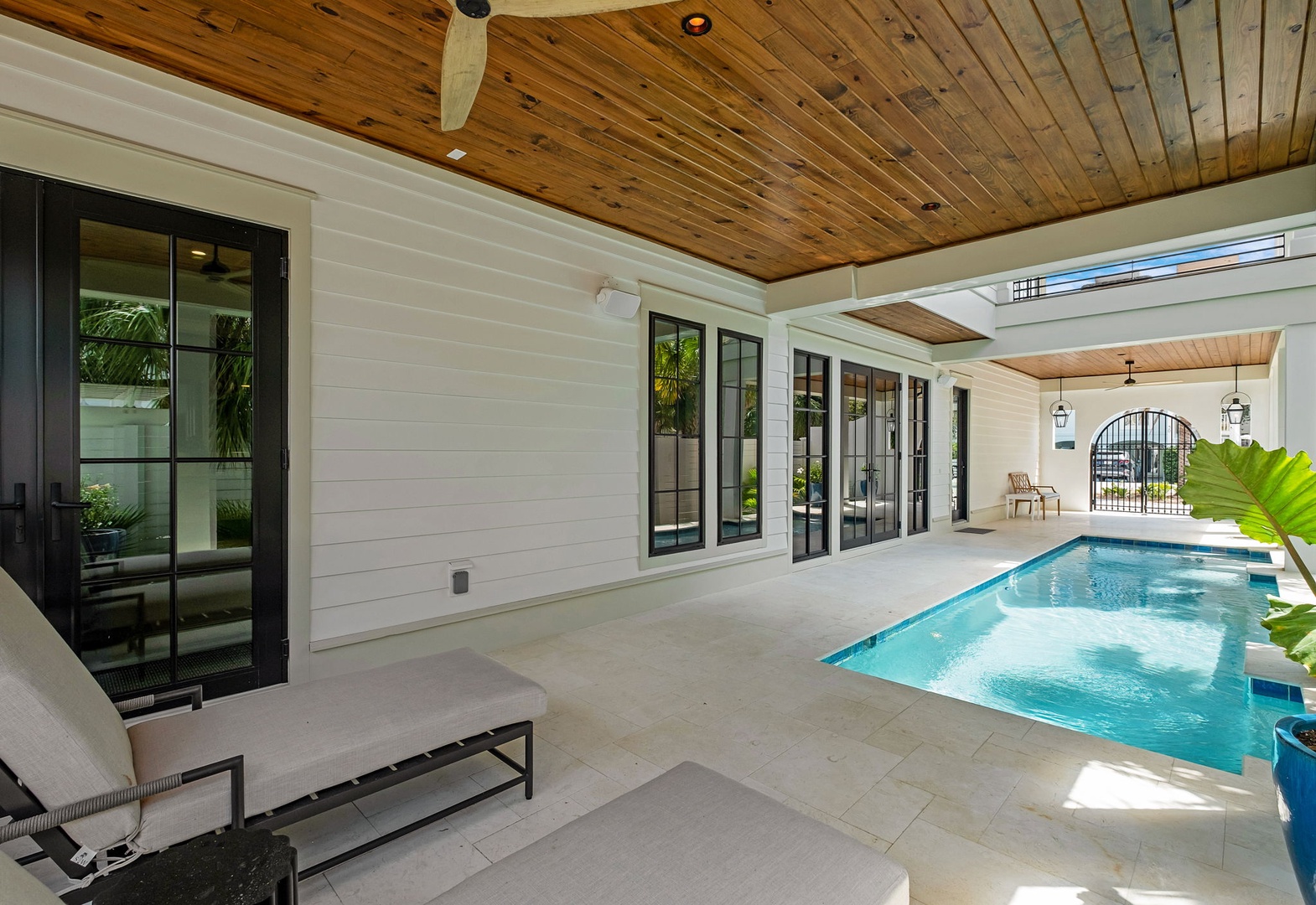 Unwind by your private pool beneath soaring wood ceilings, where modern luxury meets tropical tranquility in this stunning covered oasis.