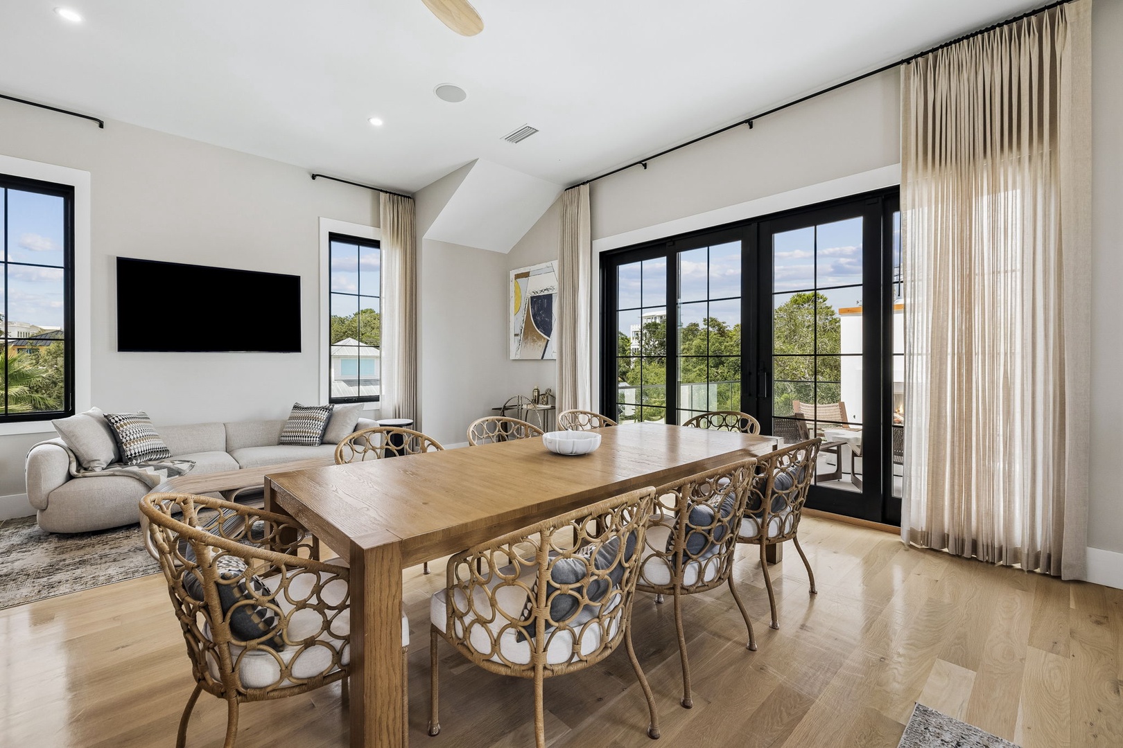 Gather around the handcrafted dining table with your group, enjoying airy ceilings and natural light streaming through floor-to-ceiling windows that frame peaceful views of the surrounding landscape.