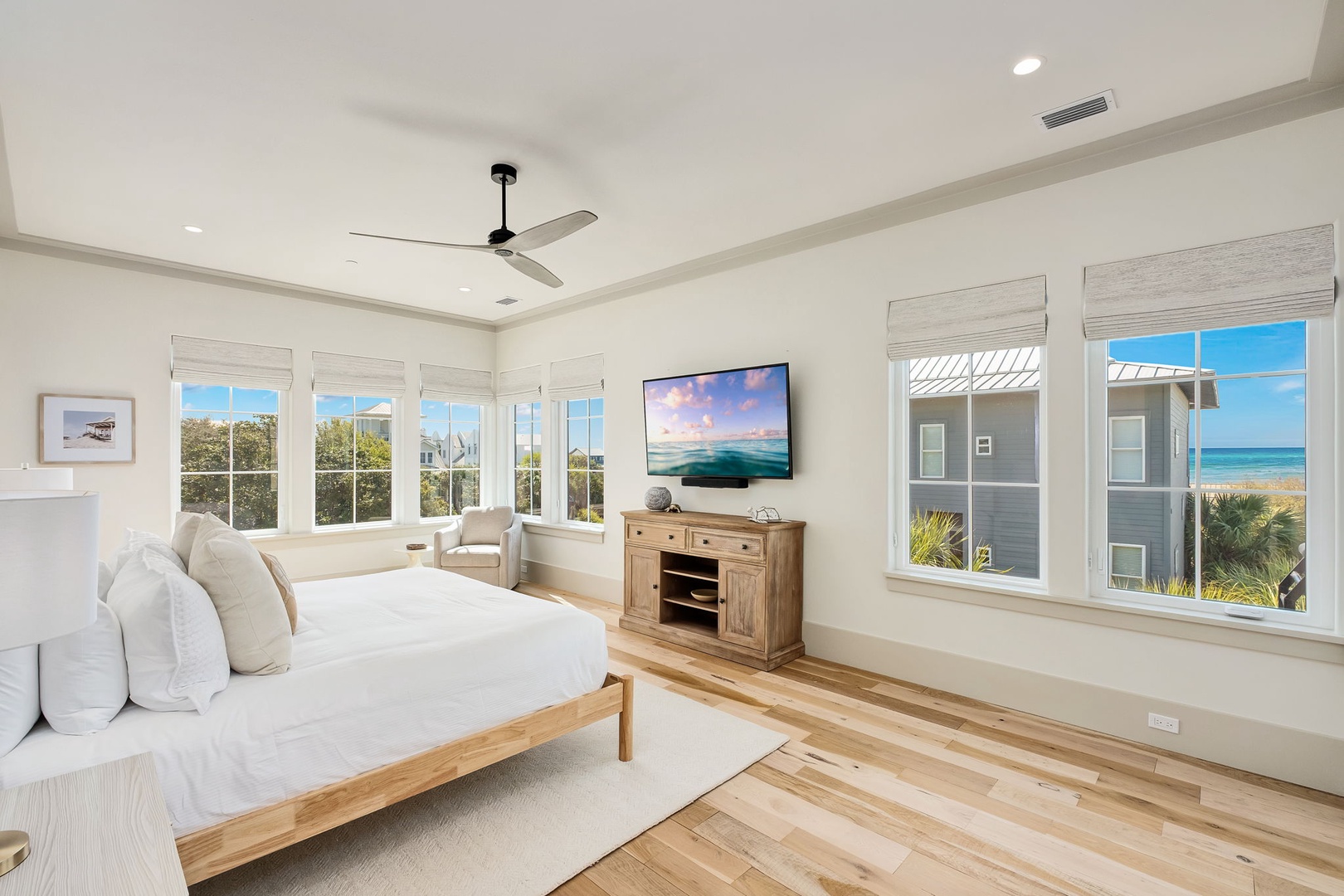 Relax in your sun-filled bedroom with stunning ocean views and a gentle ceiling fan breeze.