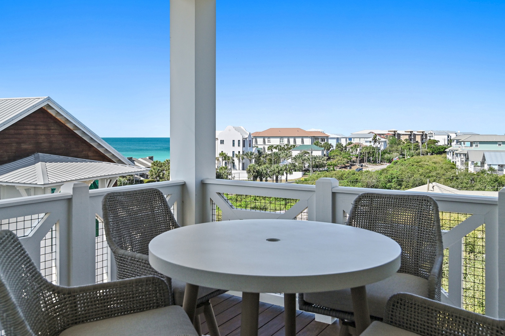 Sip morning coffee at your private table with turquoise sea views and coastal breezes just beyond the palms—your daily escape awaits.