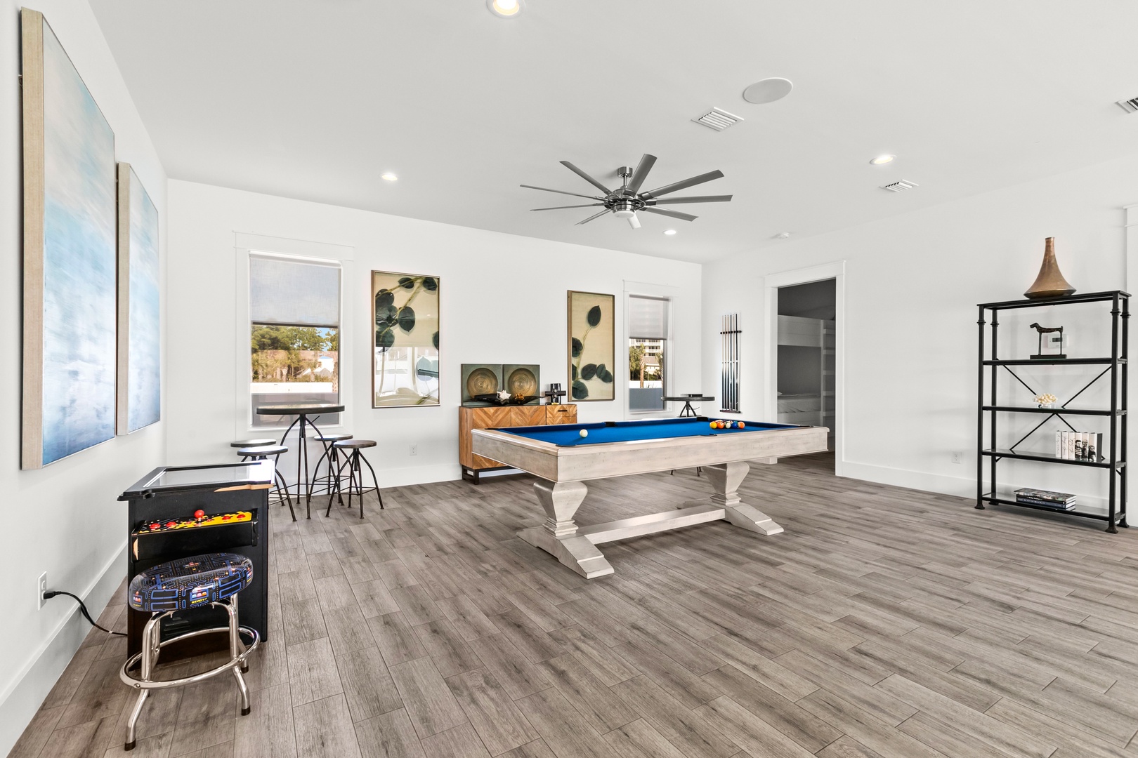Your own private game room awaits, complete with a billiard table, arcade fun, and space to unwind with friends or family under bright, open ceilings.