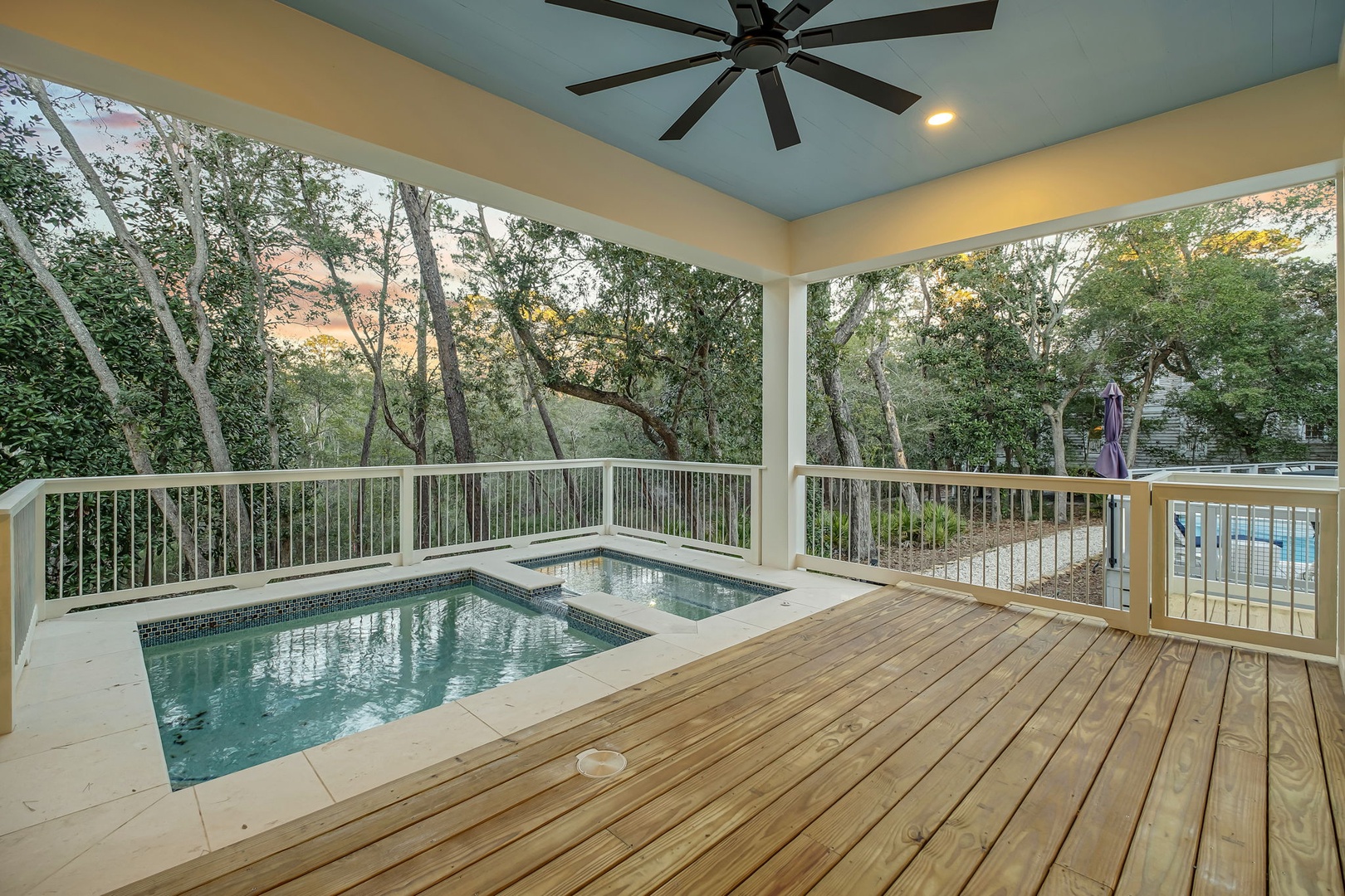 Unwind in your private hot tub on this stunning covered deck, surrounded by lush trees and gentle evening light.