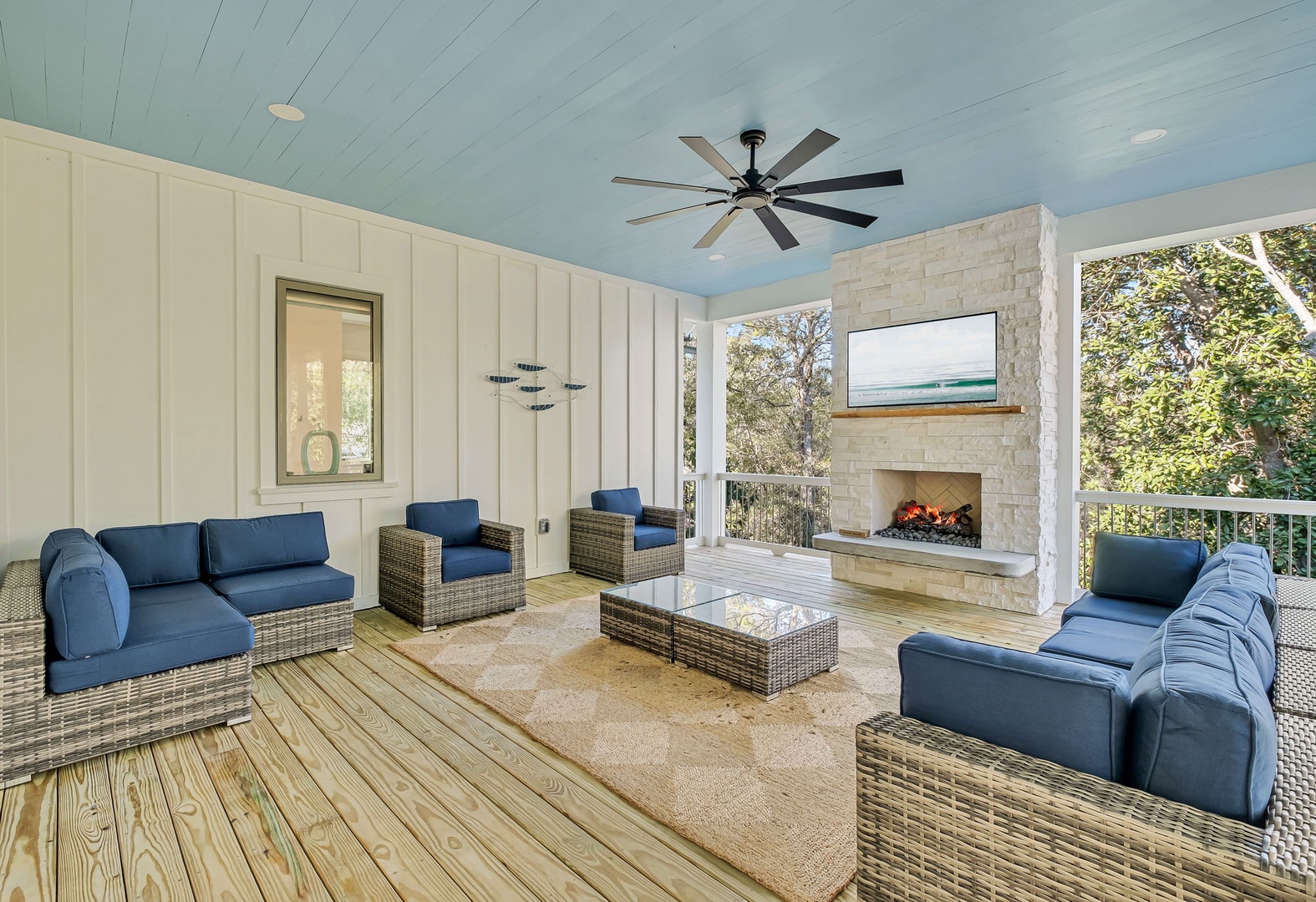 Unwind in your elegant covered terrace with plush seating, crackling fireplace, and nature views—perfect for cozy evenings.