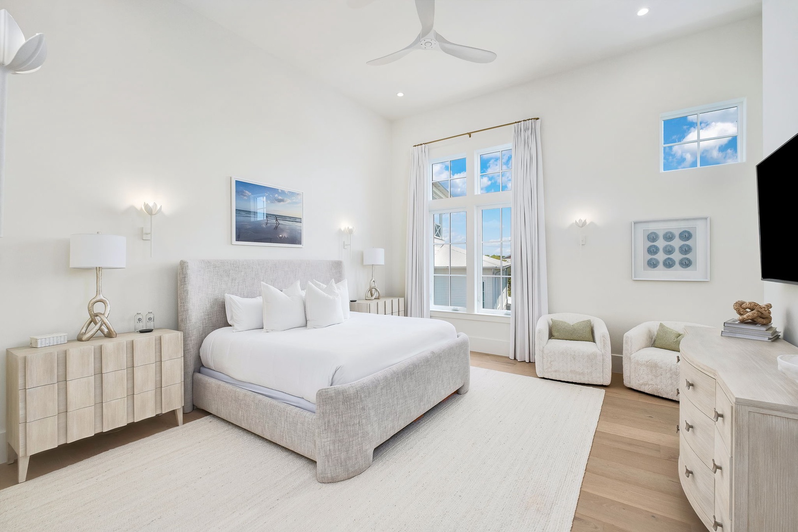 Unwind in your serene bedroom, where soft linens and coastal breezes welcome you. Wake to natural light and step through the French doors to enjoy peaceful water views from your private balcony.