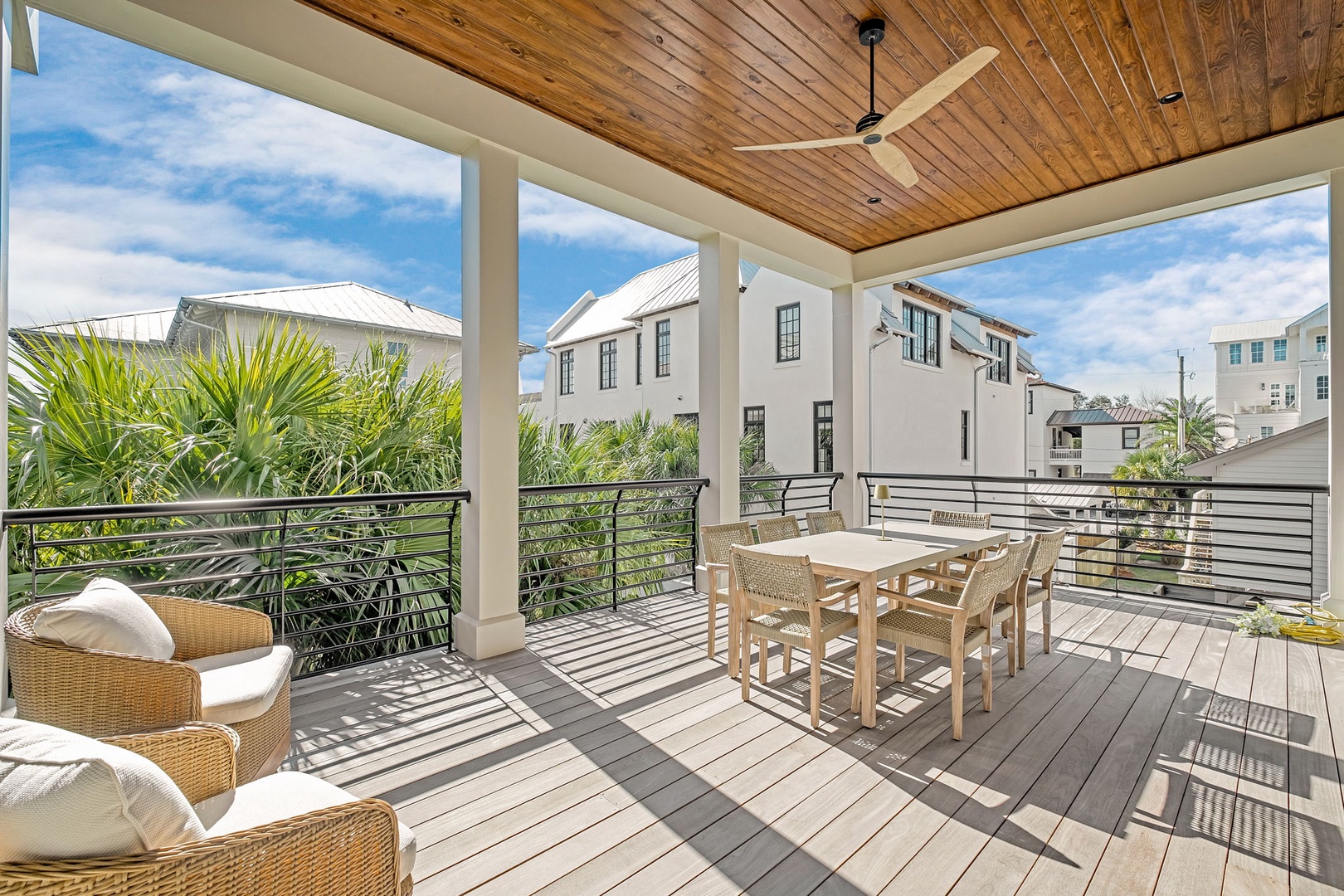 Your private covered terrace offers comfortable outdoor dining with stunning wood ceiling details and neighborhood views.
