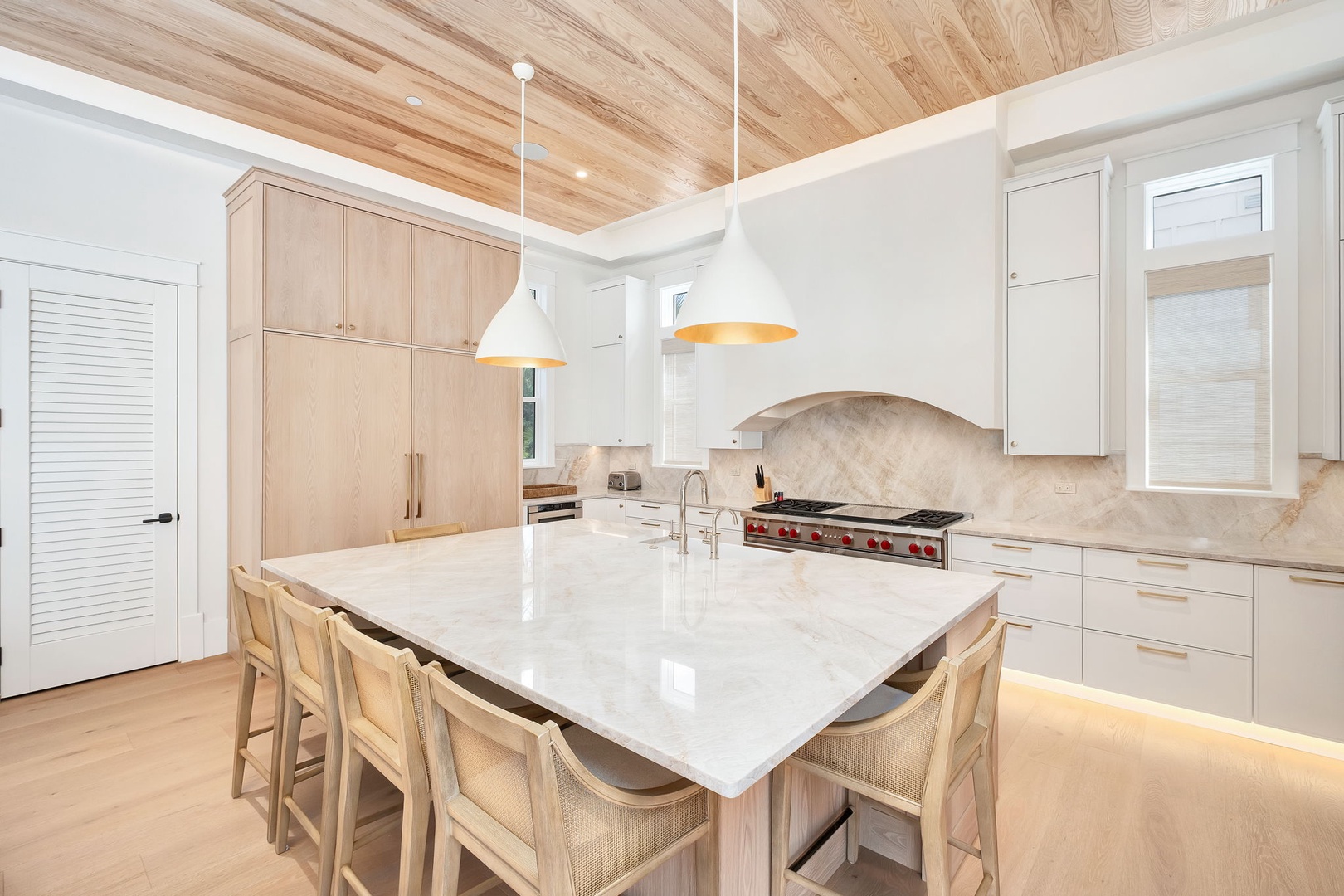 Picture yourself creating memorable meals in this stunning gourmet kitchen, where warm wood tones meet sleek marble countertops and professional-grade appliances invite your inner chef to shine.
