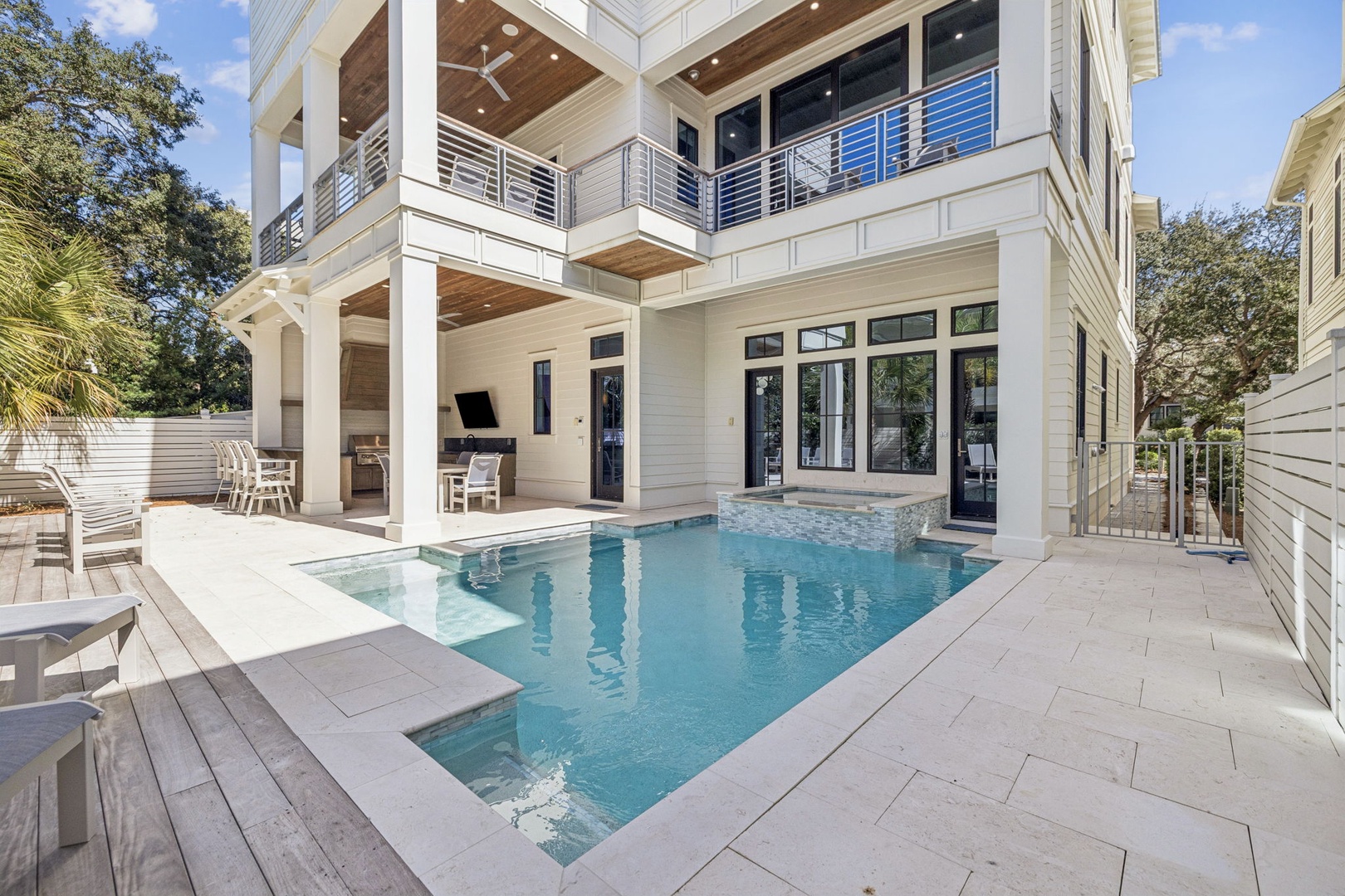 This stunning modern home features a private courtyard pool surrounded by contemporary architecture and lush tropical landscaping.