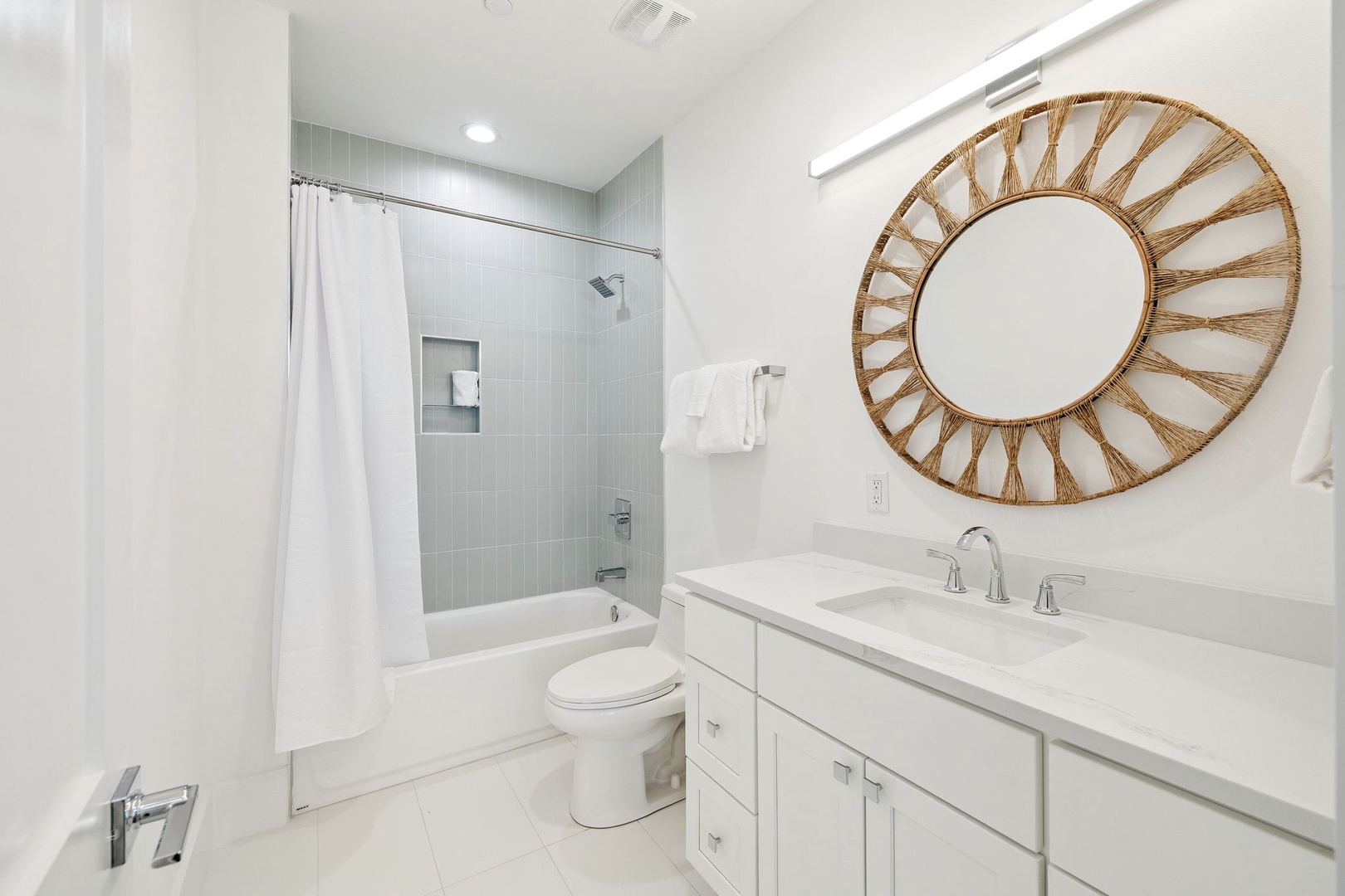 Unwind in your spa-like bathroom featuring marble countertops, a soaking tub, and elegant coastal-inspired decor that makes every moment feel like a retreat.