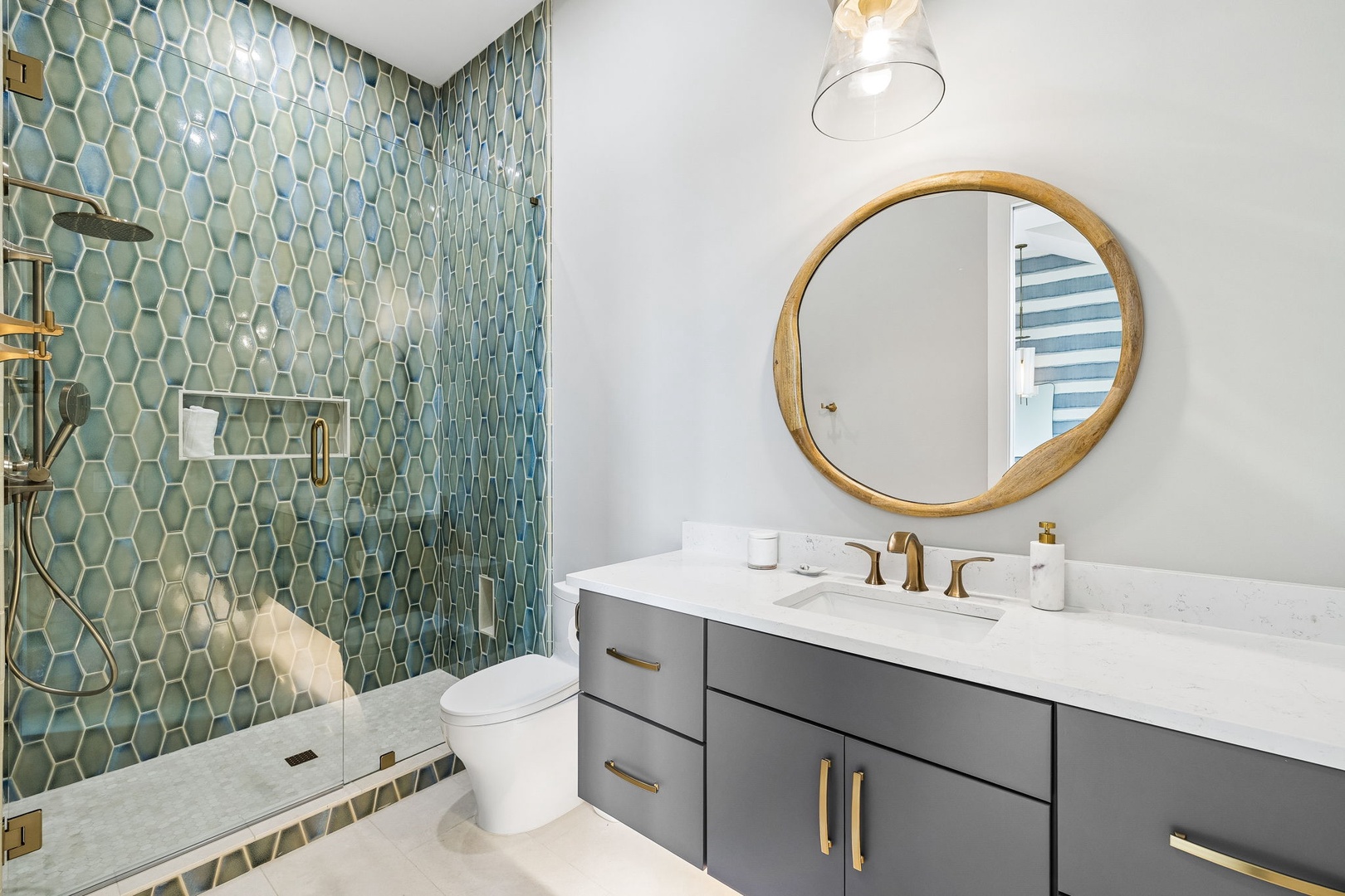 Step into your spa-like retreat with stunning teal hexagon tiles, sleek fixtures, and modern elegance designed for your ultimate relaxation.