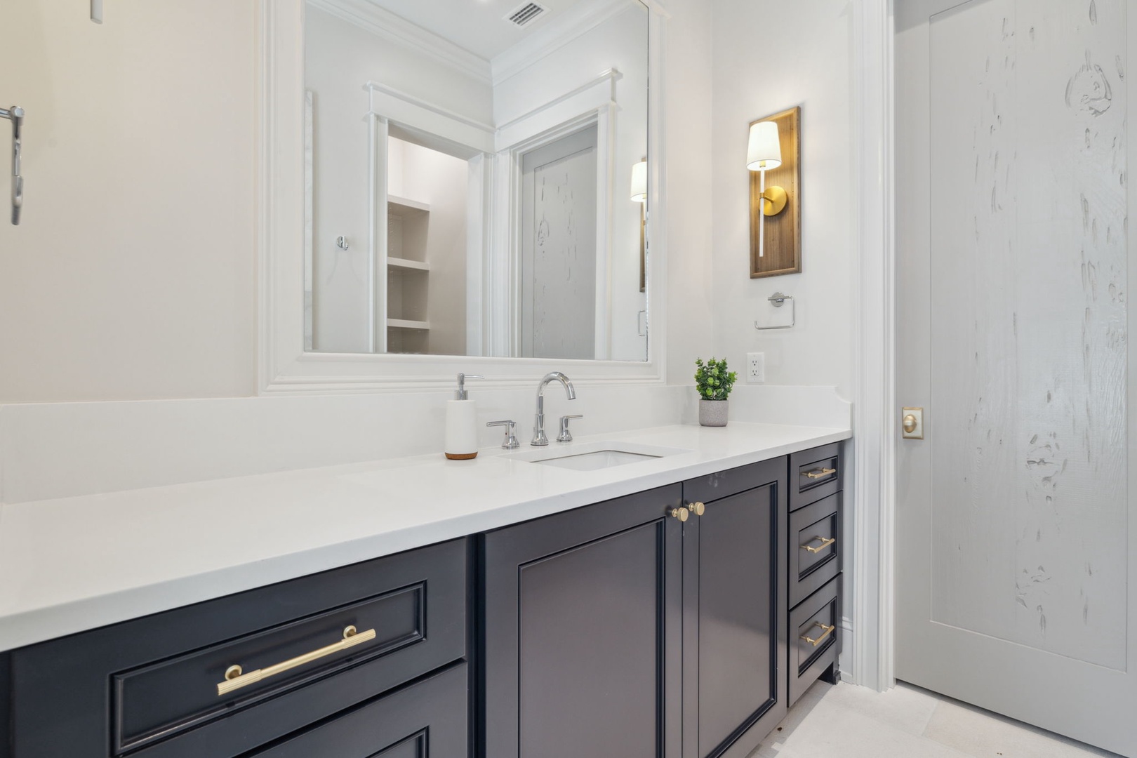 Step into your private sanctuary with crisp white walls, elegant gold accents, and pristine marble countertops that invite you to unwind and refresh in style.