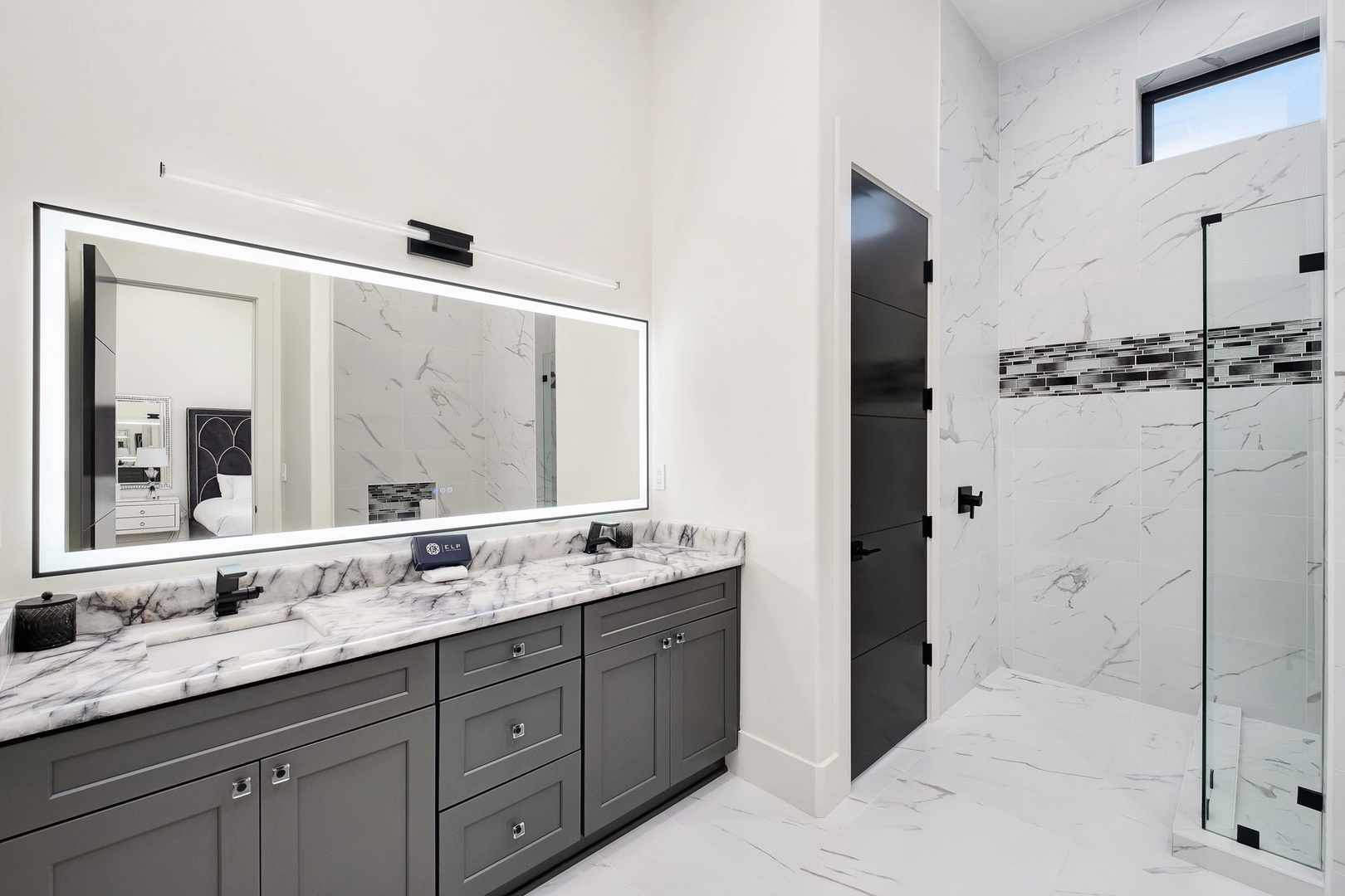 Step into your luxurious marble bathroom featuring a spacious walk-in shower and elegant vanity for your daily rituals.