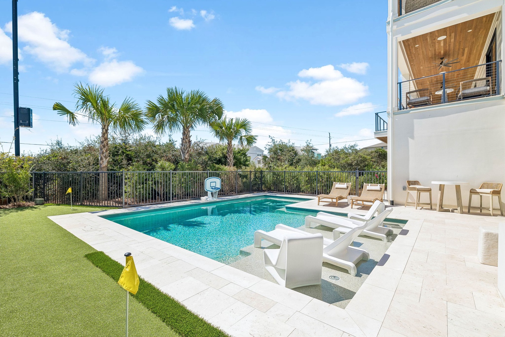 A sparkling pool and sunny deck await, framed by palm trees and lush greenery—perfect for lounging, splashing, and soaking up the Florida sunshine.