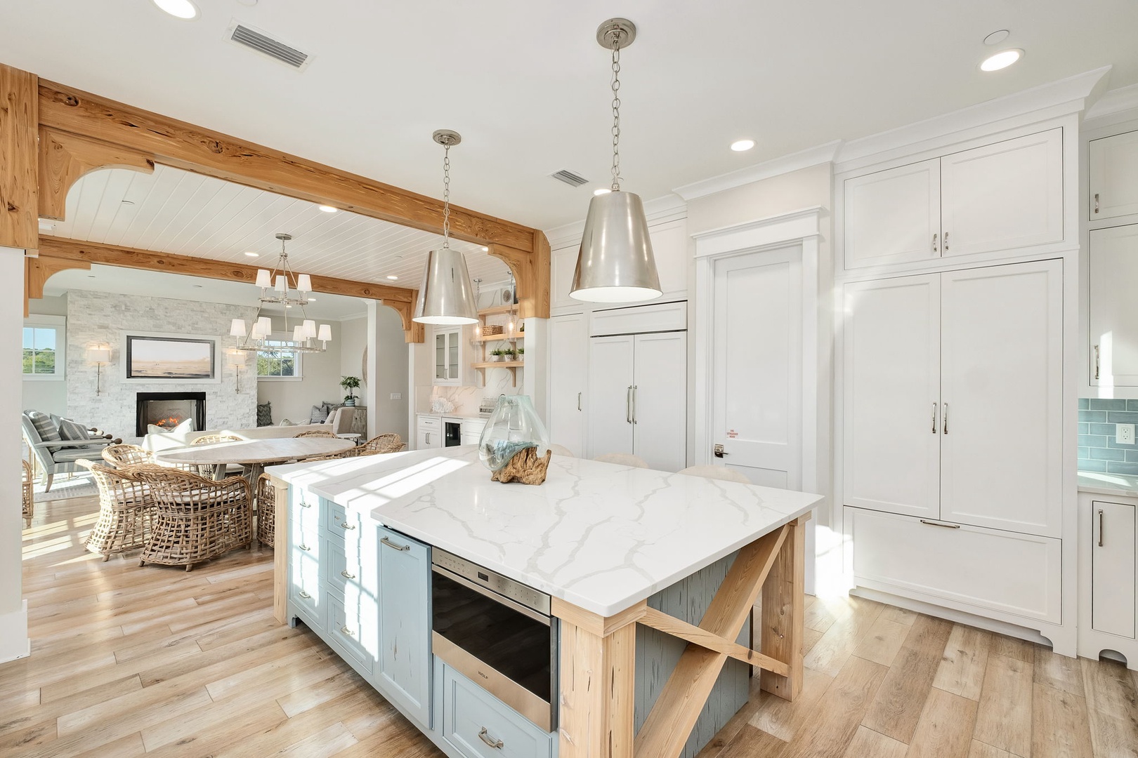 Your gourmet kitchen awaits with marble countertops, custom cabinetry, and warm wood beams creating the perfect space for cooking memorable meals.