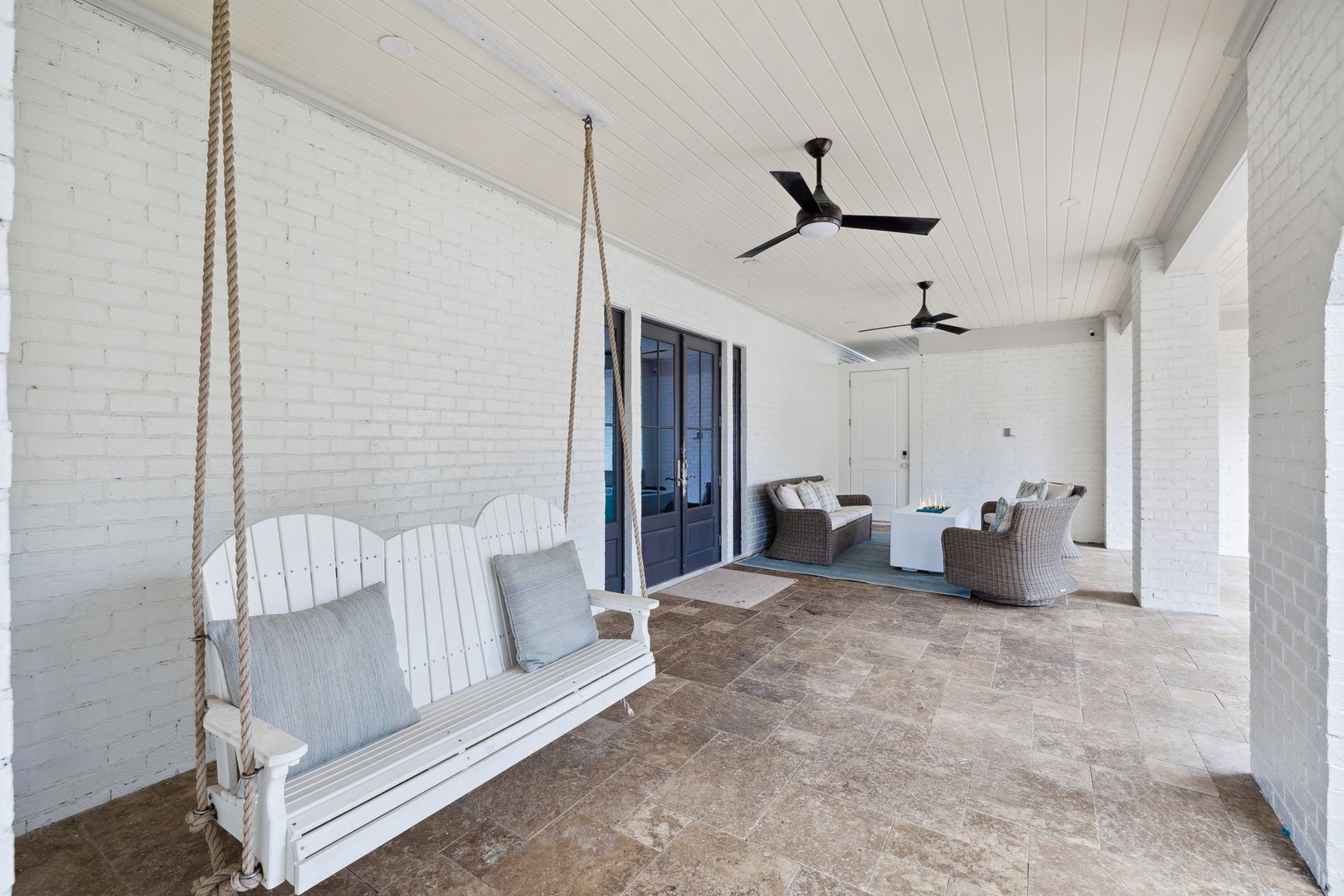 Settle into your private porch swing with morning coffee, then gather around the seating area for evening conversations under gentle ceiling fans.