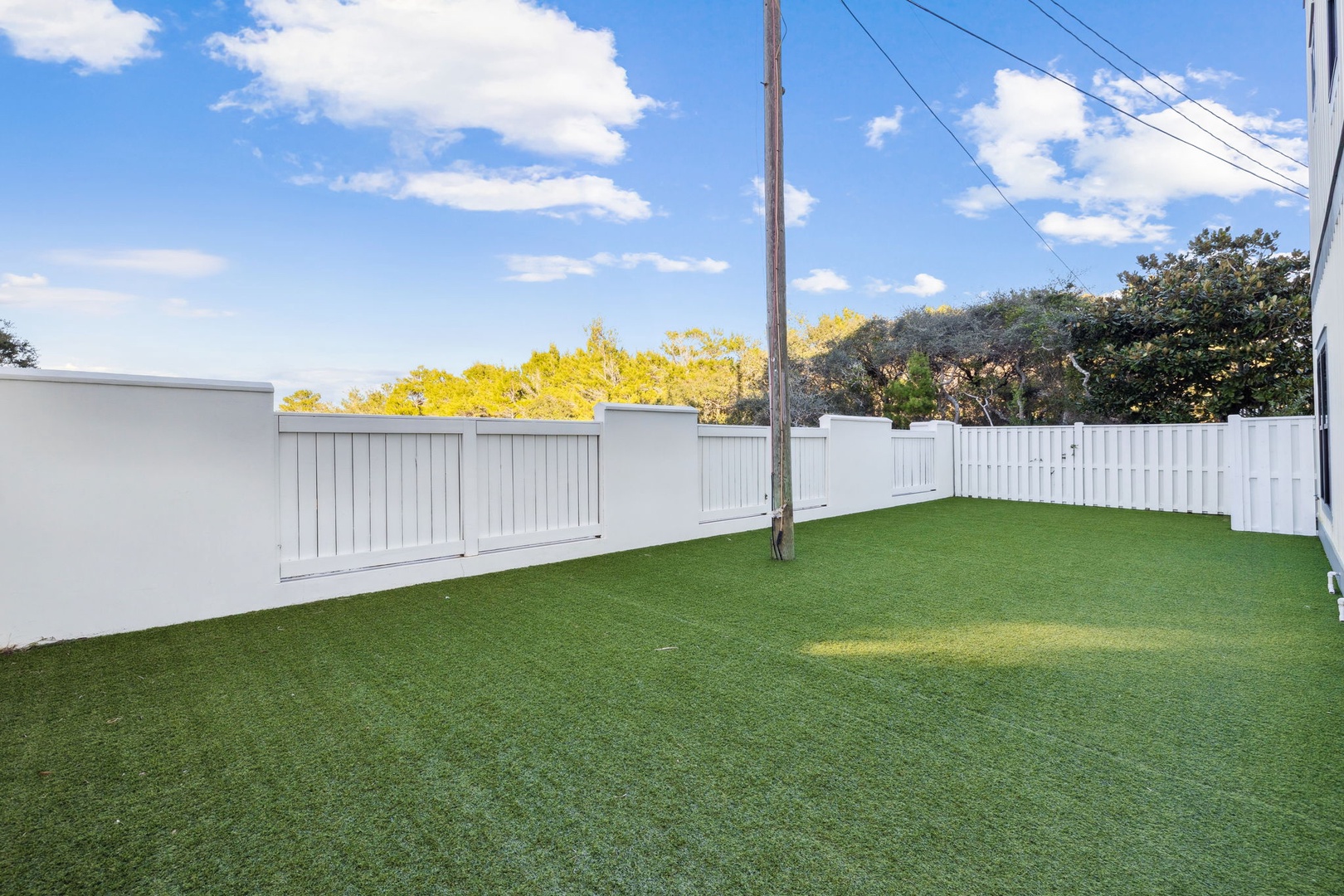 Your private backyard offers perfect space for morning coffee or evening gatherings on lush artificial turf.