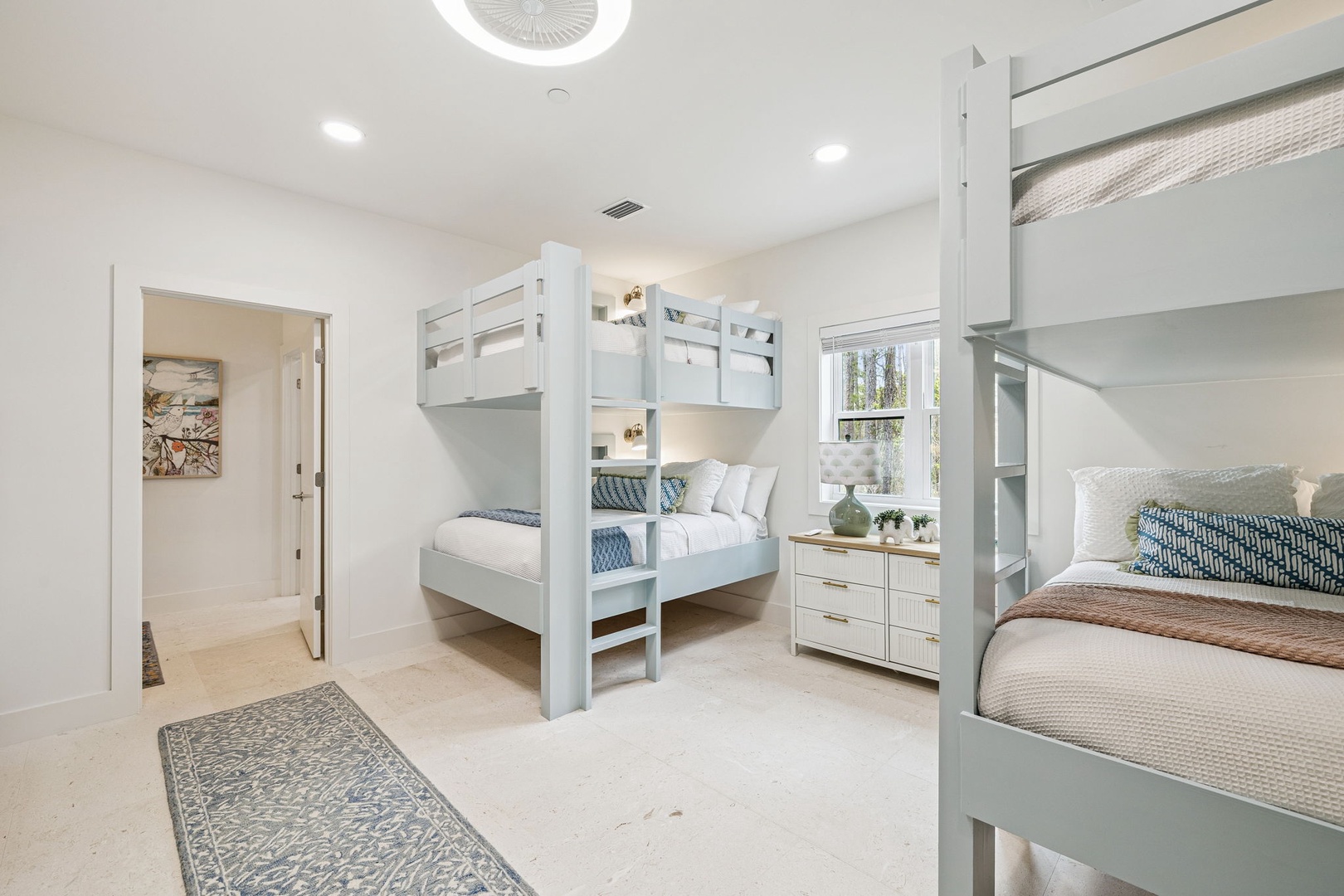 Your kids will love this bright bunk room with two sets of twin beds, perfect for family adventures and sweet dreams.