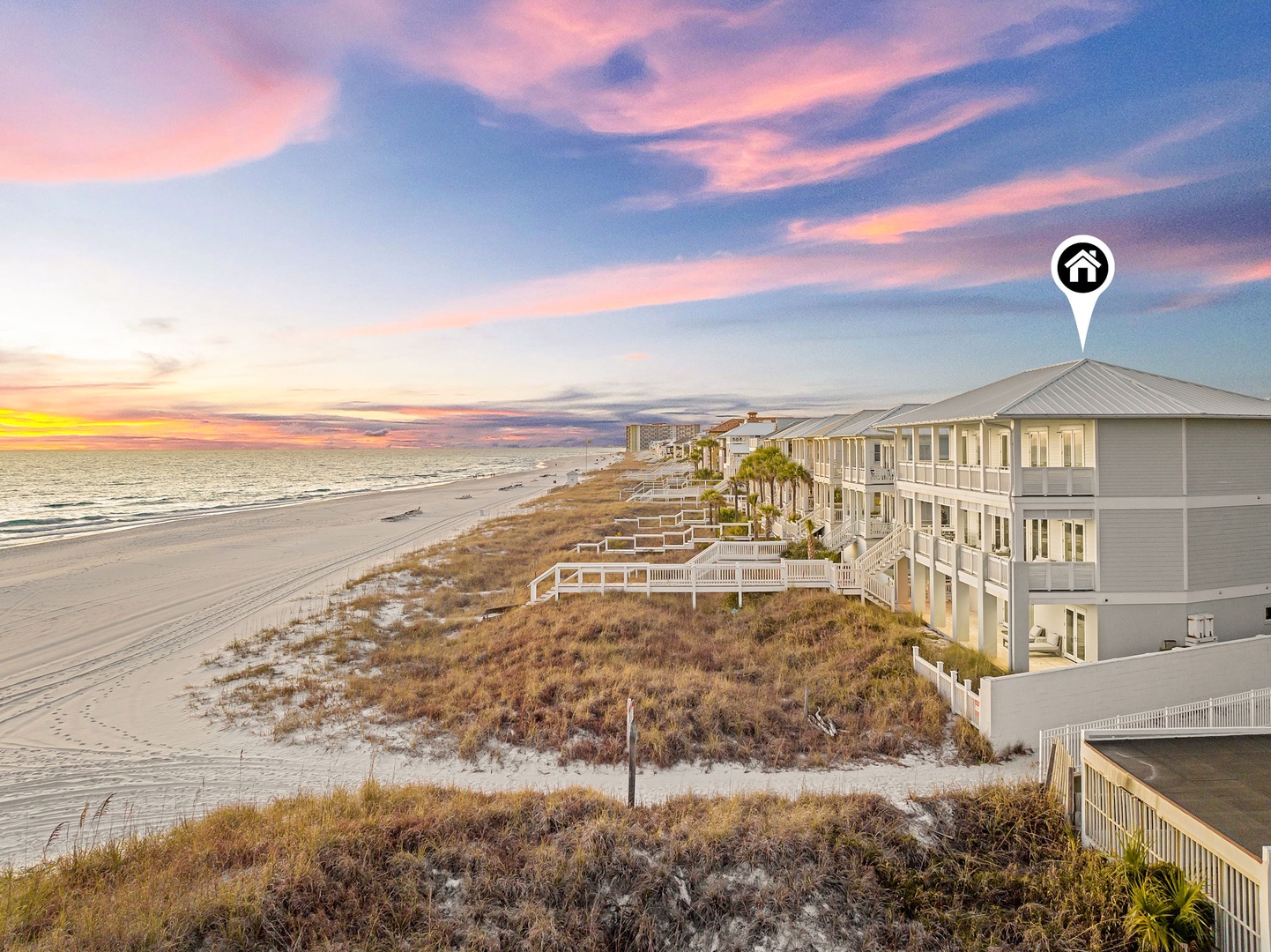 Beachfront property nestled along pristine sandy shores with stunning sunset views over the Gulf, surrounded by natural coastal dunes and swaying palms.