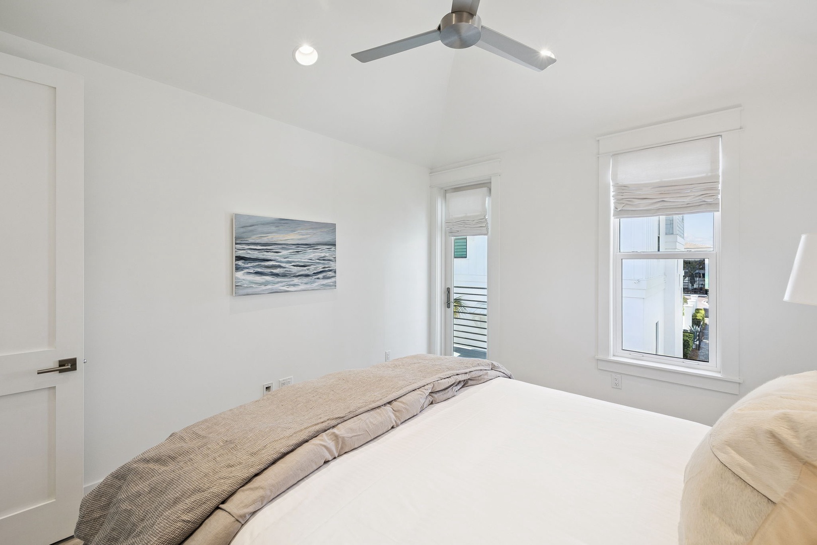 Drift off to sleep in this serene bedroom, where soft linens and gentle ocean artwork create your peaceful coastal retreat.