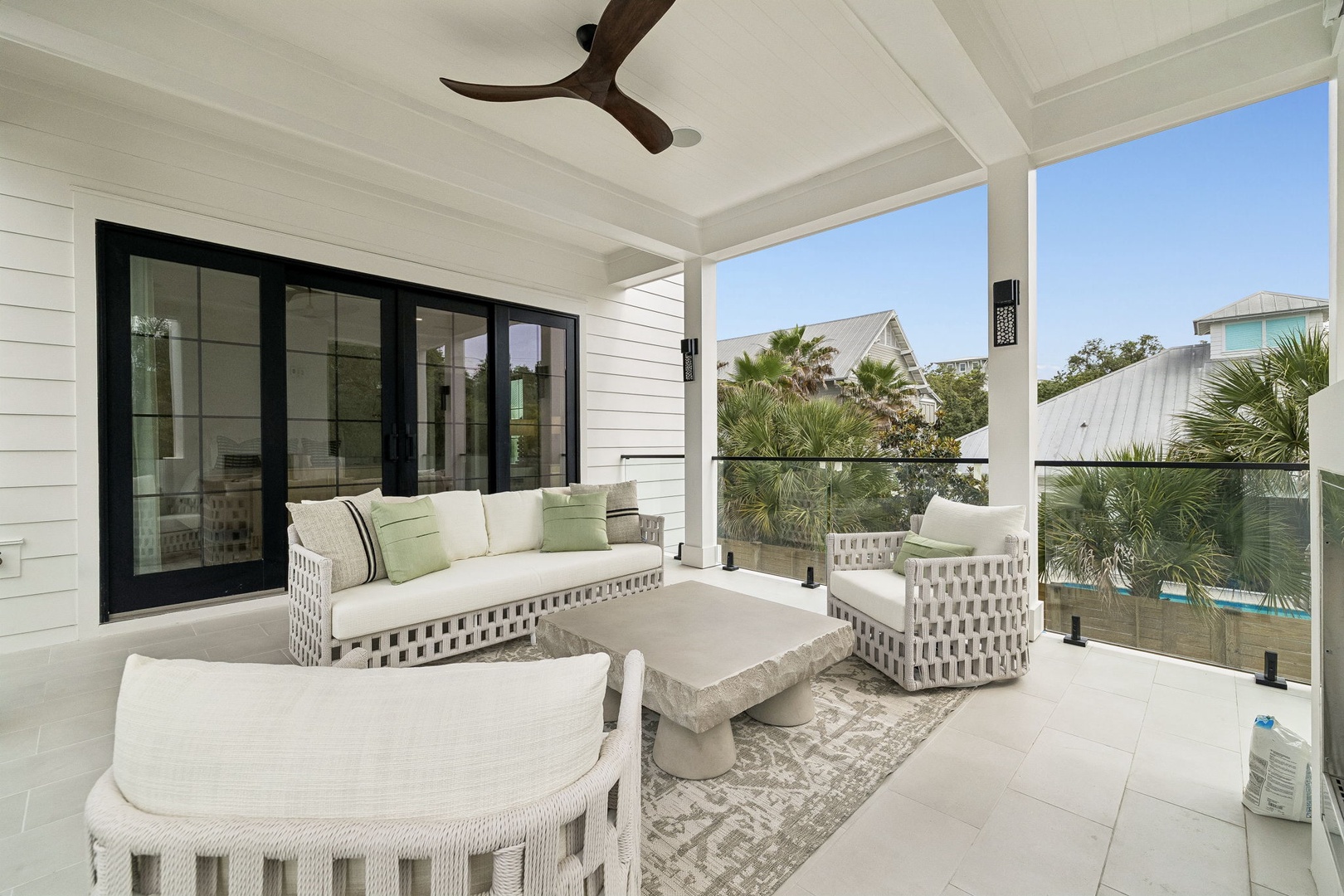 Your private covered patio invites relaxation with plush seating and tropical views, perfect for morning coffee or sunset cocktails in the coastal breeze.