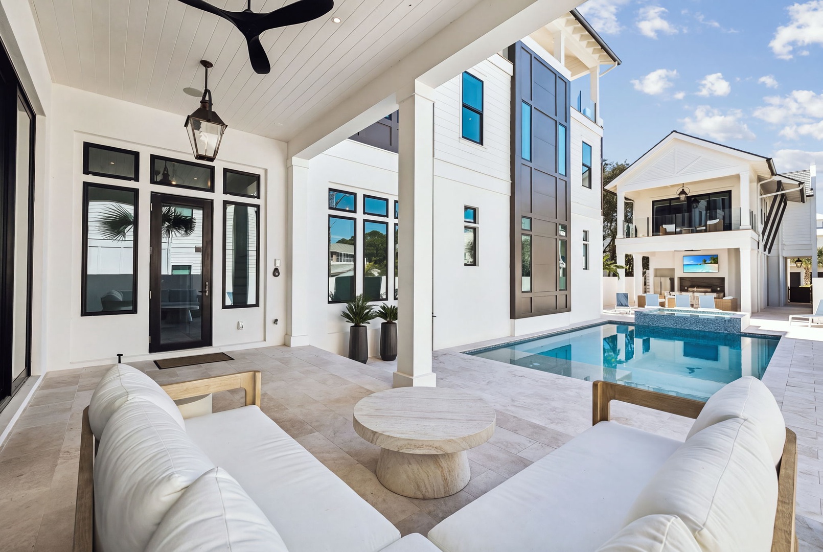 Sink into plush seating on your covered patio and let the coastal breeze wash over you as you gaze at your private pool framed by modern architecture.