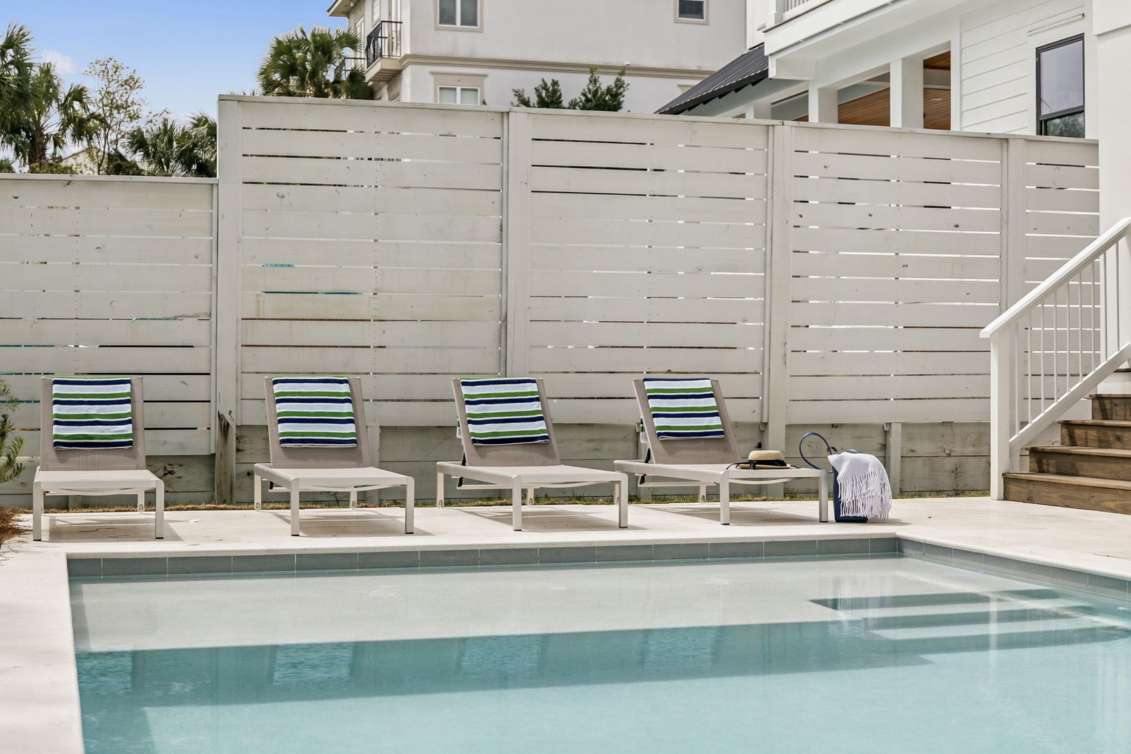 Dive into your private oasis with pristine pool waters and comfortable loungers for ultimate relaxation.