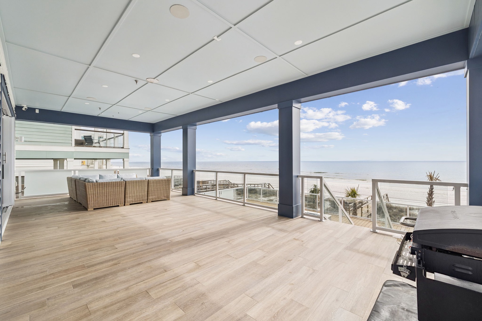Relax on your spacious covered terrace with wicker seating and stunning ocean views stretching to the horizon.