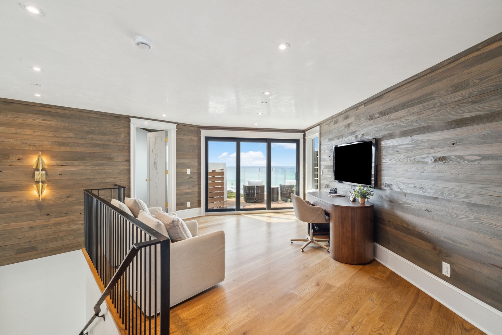 Relax in this stylish upper-level retreat, where warm wood tones and panoramic ocean views create your perfect escape. Catch your favorite show on the wall-mounted TV or simply unwind as natural light spills across the sleek hardwood floors.