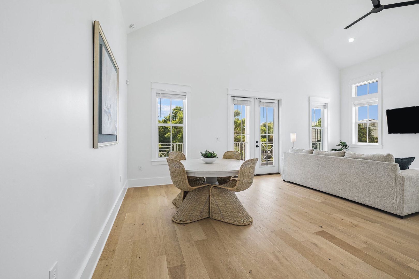 Step into your airy living space, where high ceilings and warm oak floors create a sense of calm and openness. Through the French doors, your private balcony awaits with peaceful garden views.