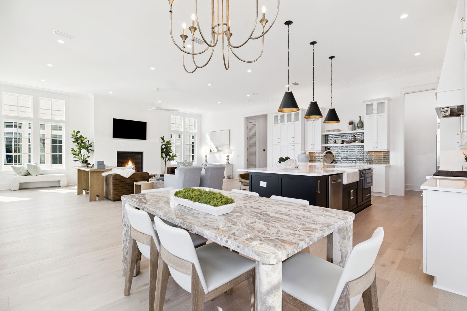 Step into your luxurious open-concept living space where marble dining table meets gourmet kitchen—perfect for memorable gatherings.