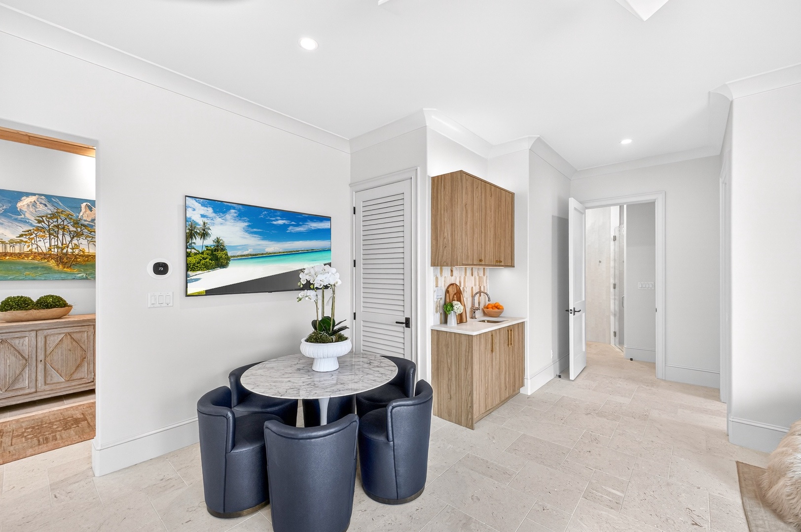 Your stylish dining nook offers intimate meals with modern comfort, complemented by a convenient kitchenette for easy meal prep.