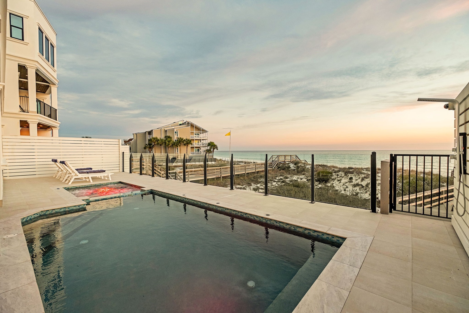 Beachfront property with private pool, Gulf of Mexico access, and stunning coastal views at sunset.