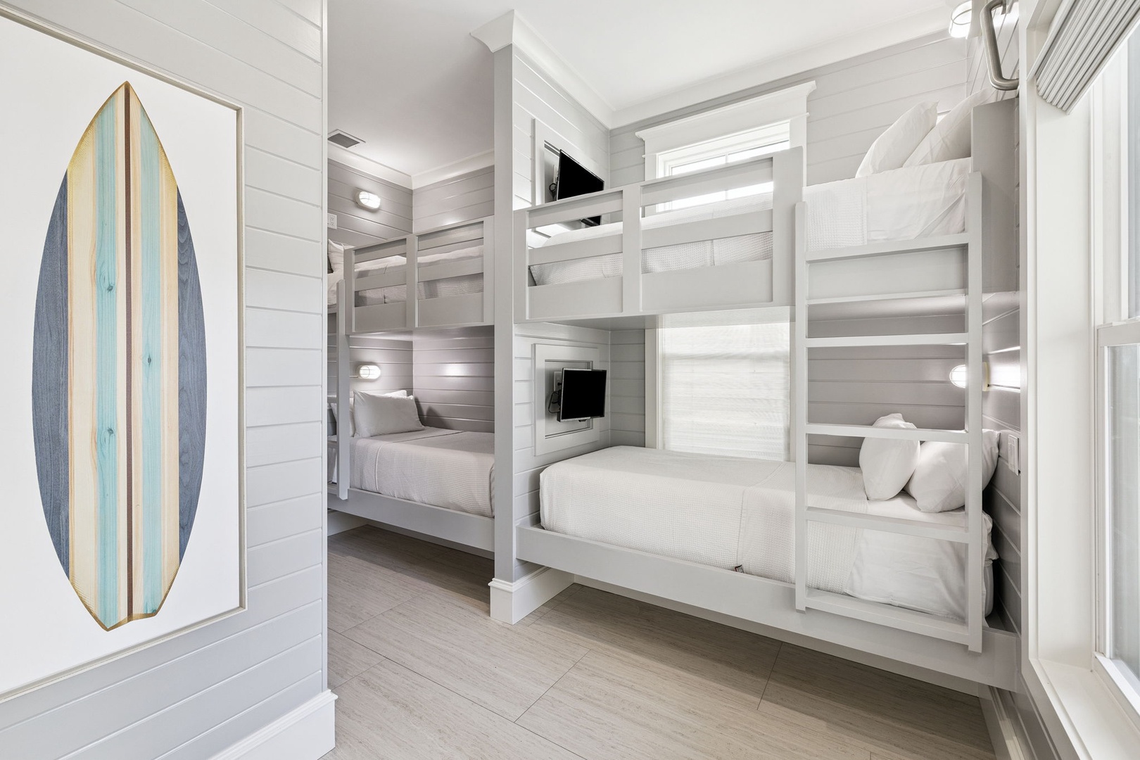 Drift off in your cozy built-in bunk bed, complete with personal TV and soft linens in this coastal-themed retreat.